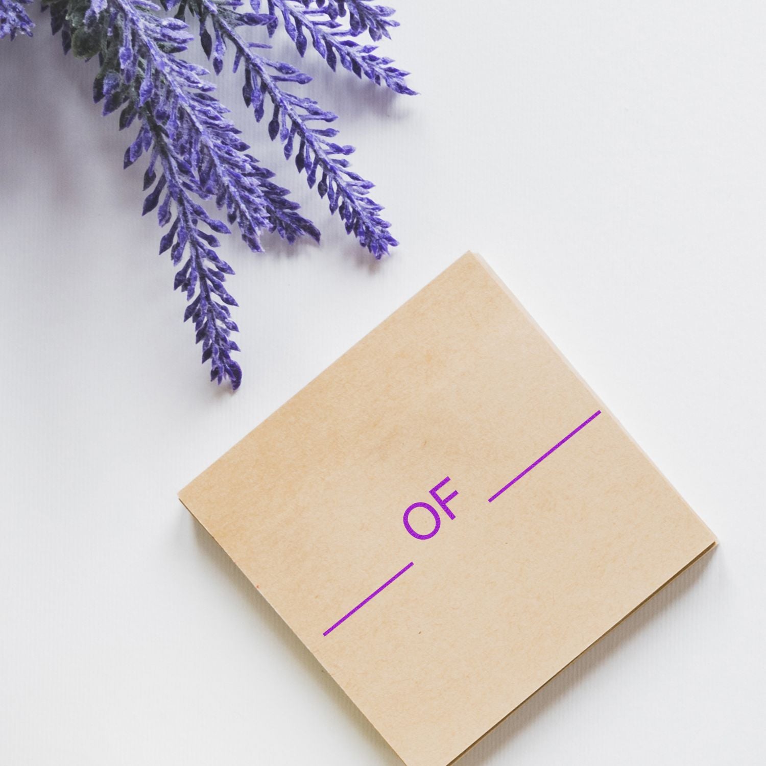 Kraft paper envelope flat lay with purple OF marking and purple foliage, minimalist packaging and branding on a white background.