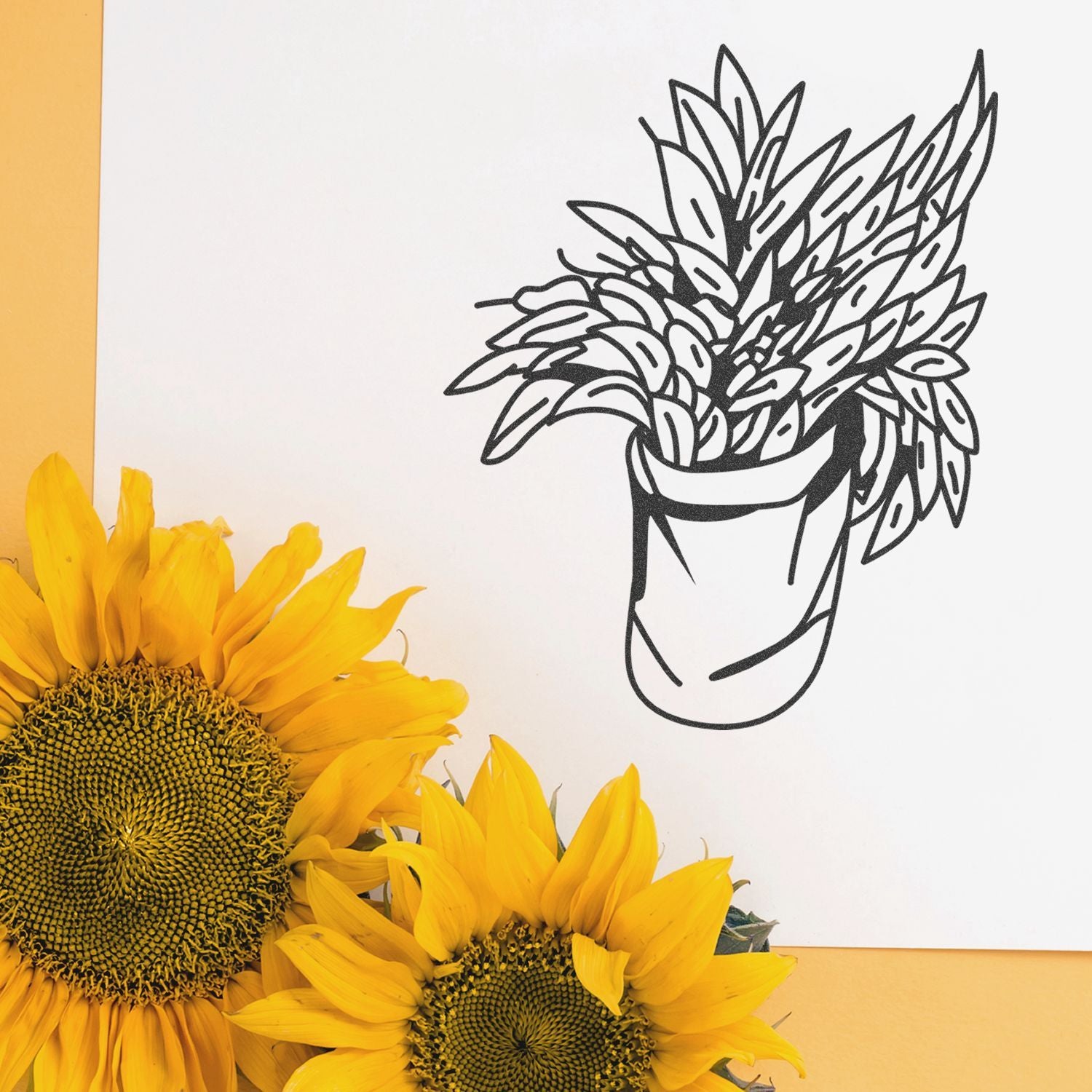 Bright yellow sunflowers beside minimalist black line art potted plant on white and yellow background.