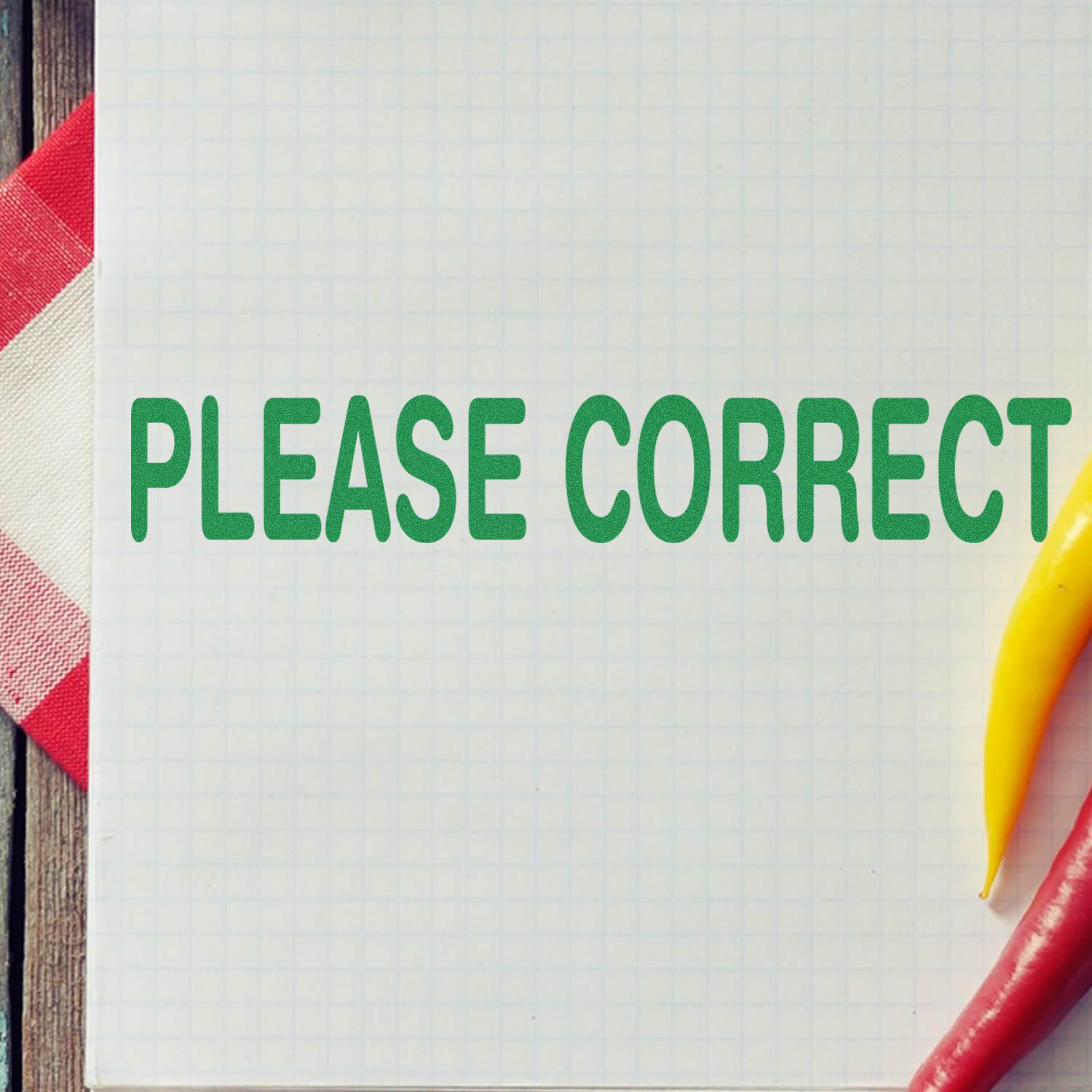 Please Correct note on graph paper with colored pencils, educational reminder for reviewing and proofreading written work assignments.