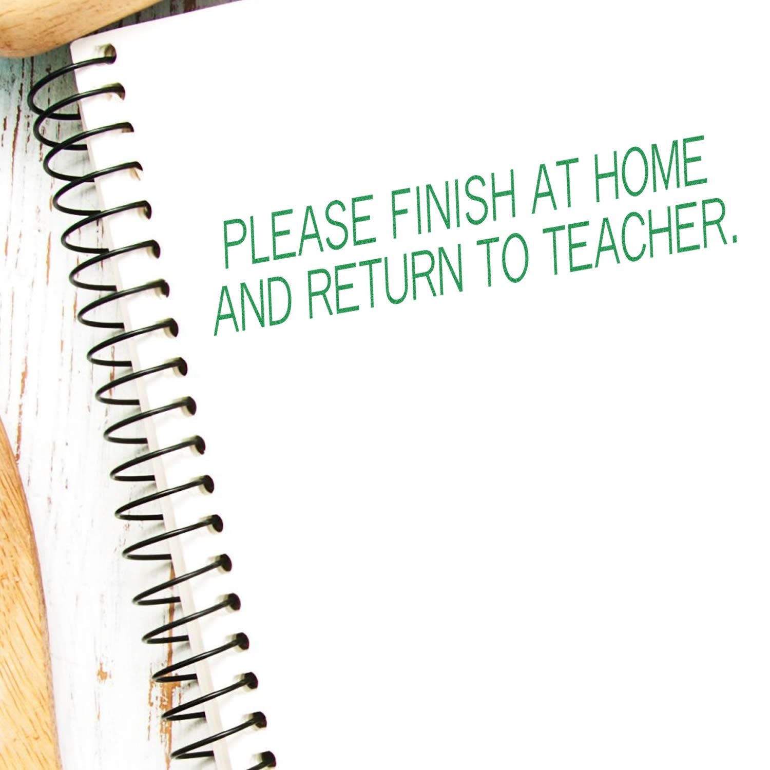 Spiral notebook page with Please finish at home and return to teacher homework reminder text.