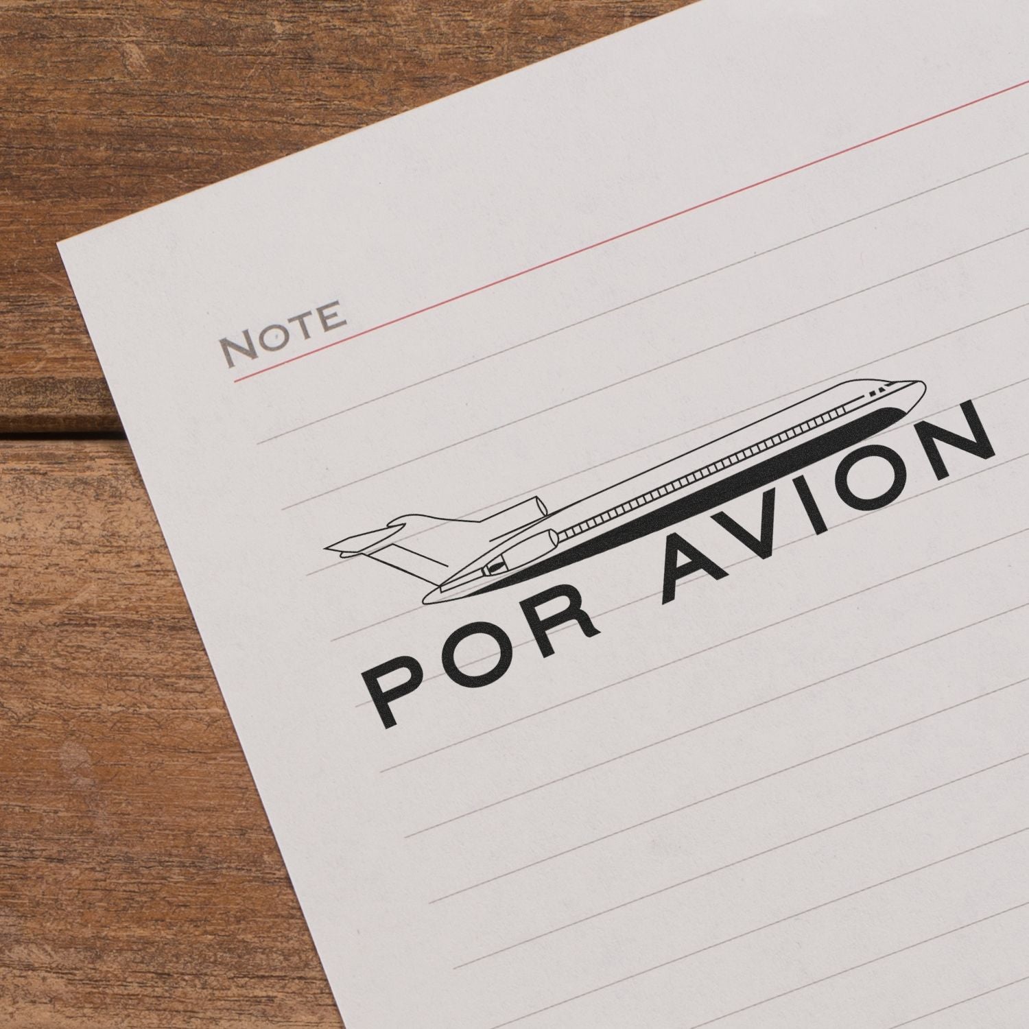 Travel note on paper with airplane illustration and Por Avin/By Air text, promoting air travel or shipping.