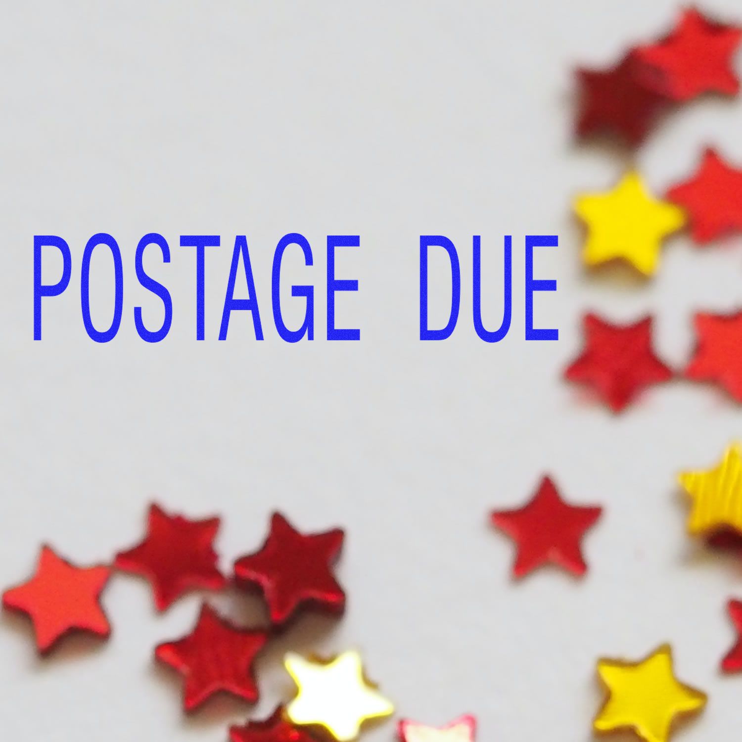 Postage due text with red and yellow star confetti on a white background.