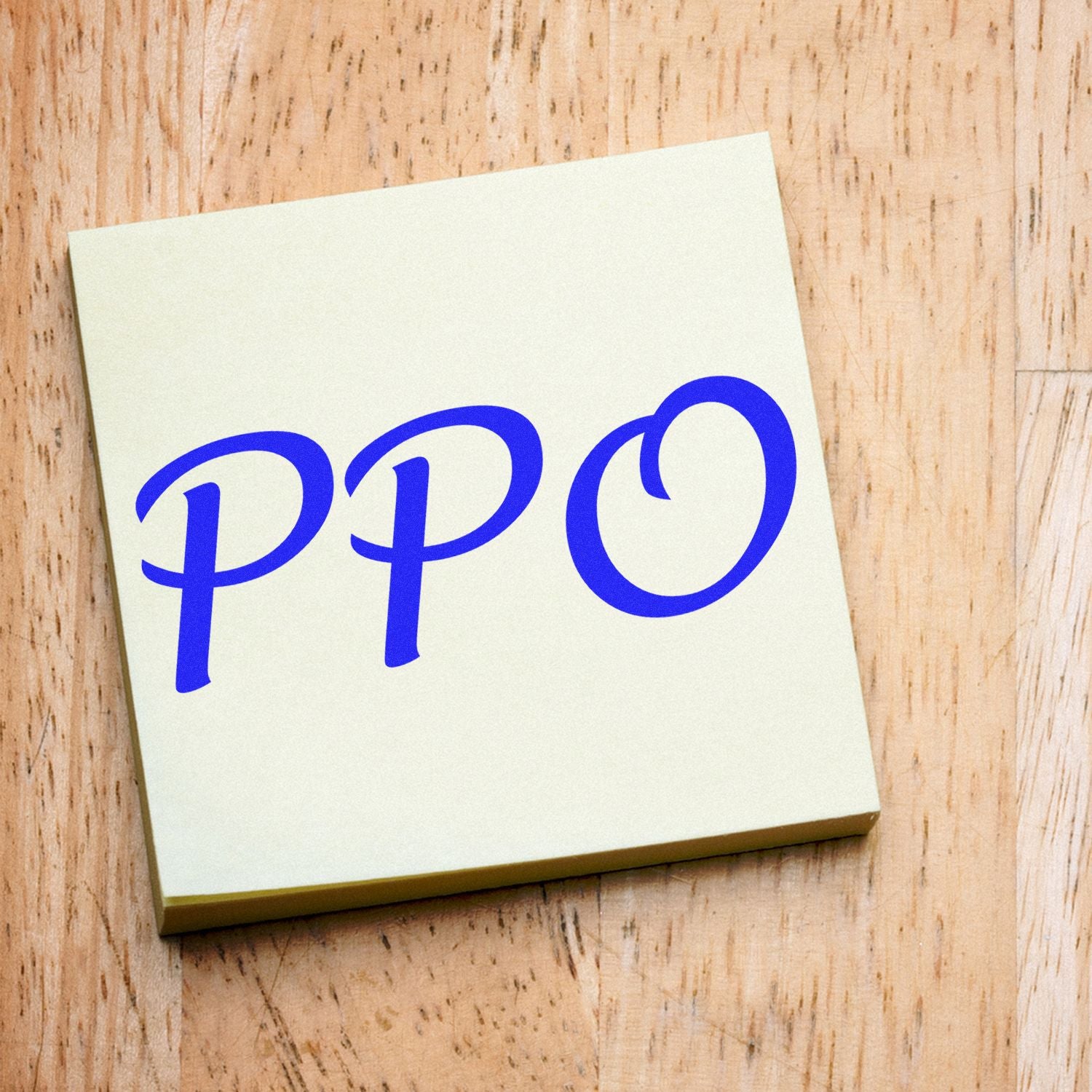White card with blue stylized ppo branding logo on a wooden background, used for product identity and marketing.