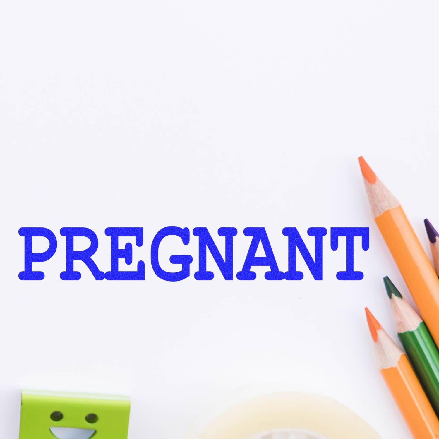 Pregnant text with colored pencils on a white background, illustrating pregnancy awareness and prenatal education concept.
