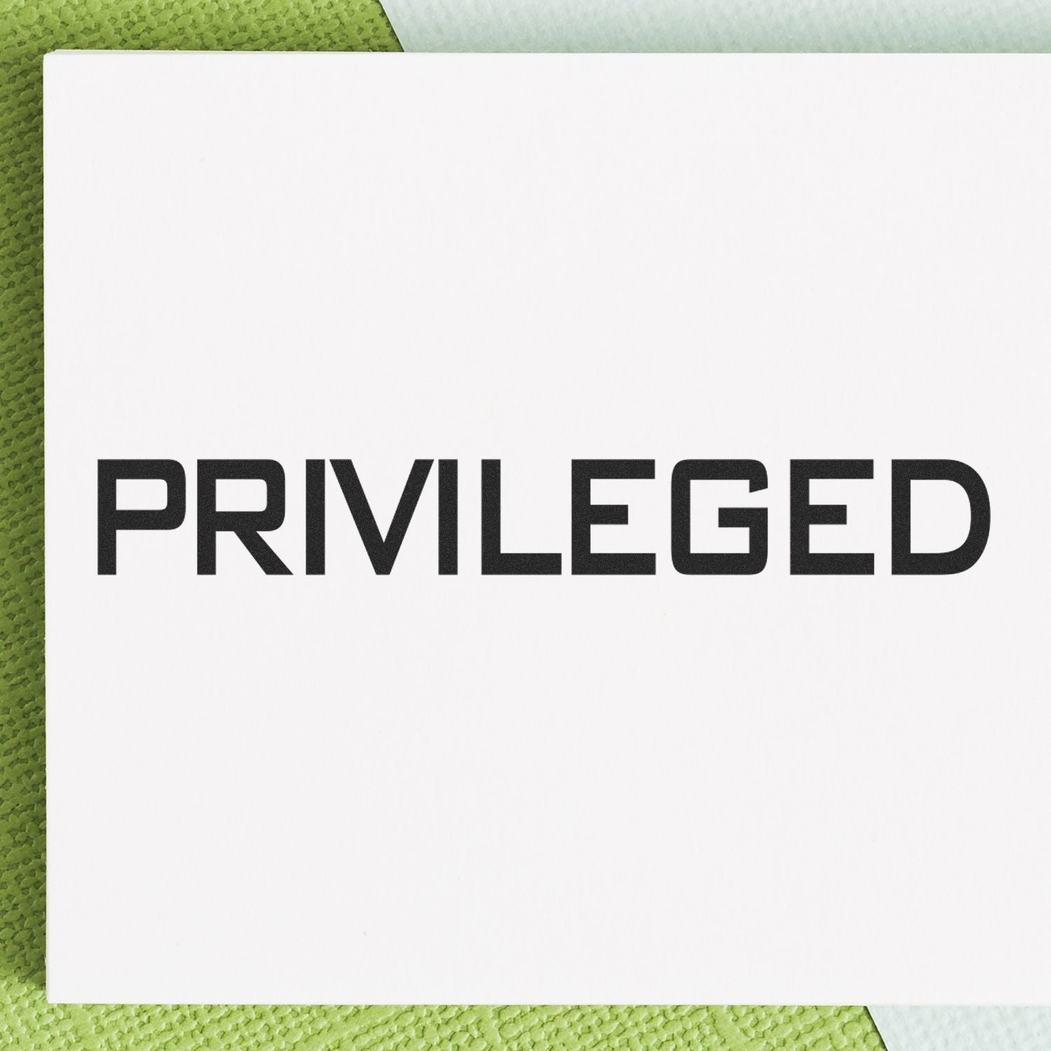 White card with bold PRIVILEGED text on a green textured background, concept of privilege and social status.