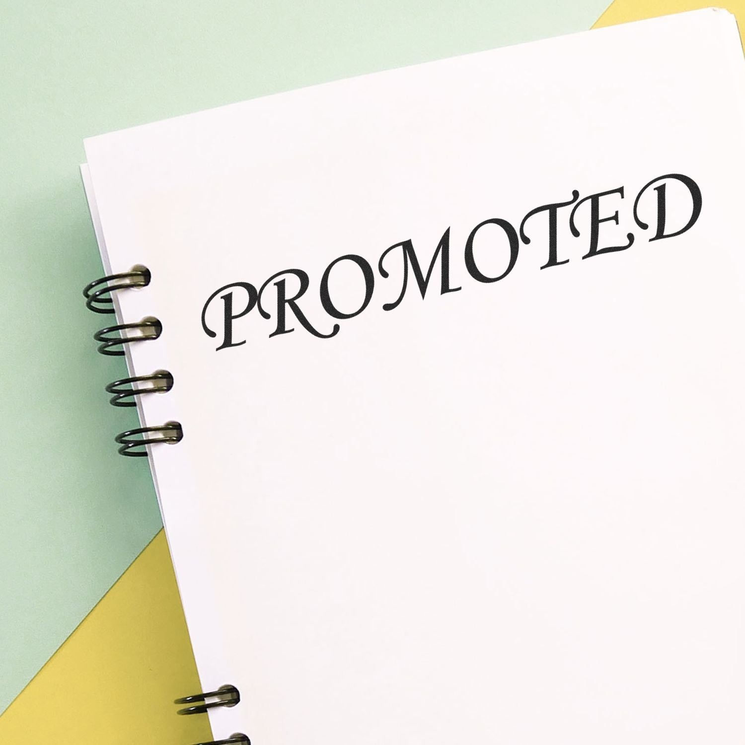 Promoted text on a spiral notebook page with pastel background, representing career advancement or marketing success.