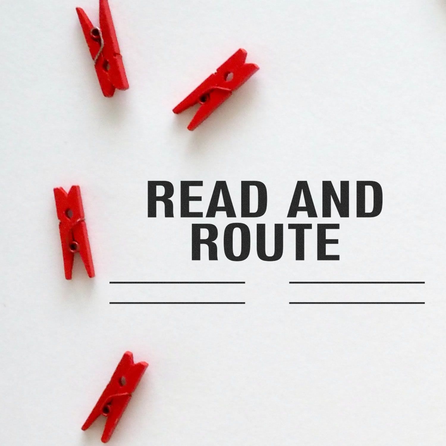 Red clothespins on white background with the text READ AND ROUTE, promoting reading and learning.