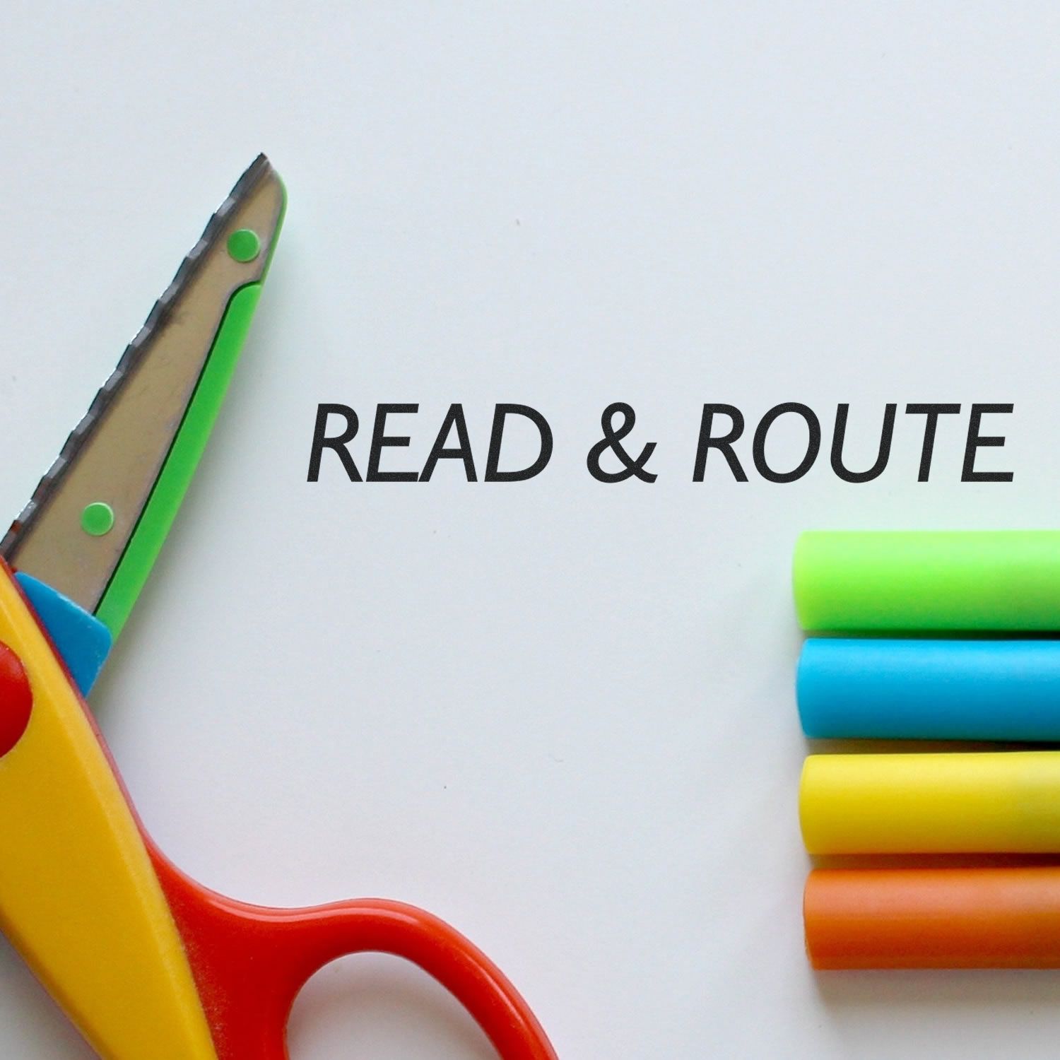 Scissors and colorful markers with READ & ROUTE text, promoting reading-themed learning activities for schools and kids.