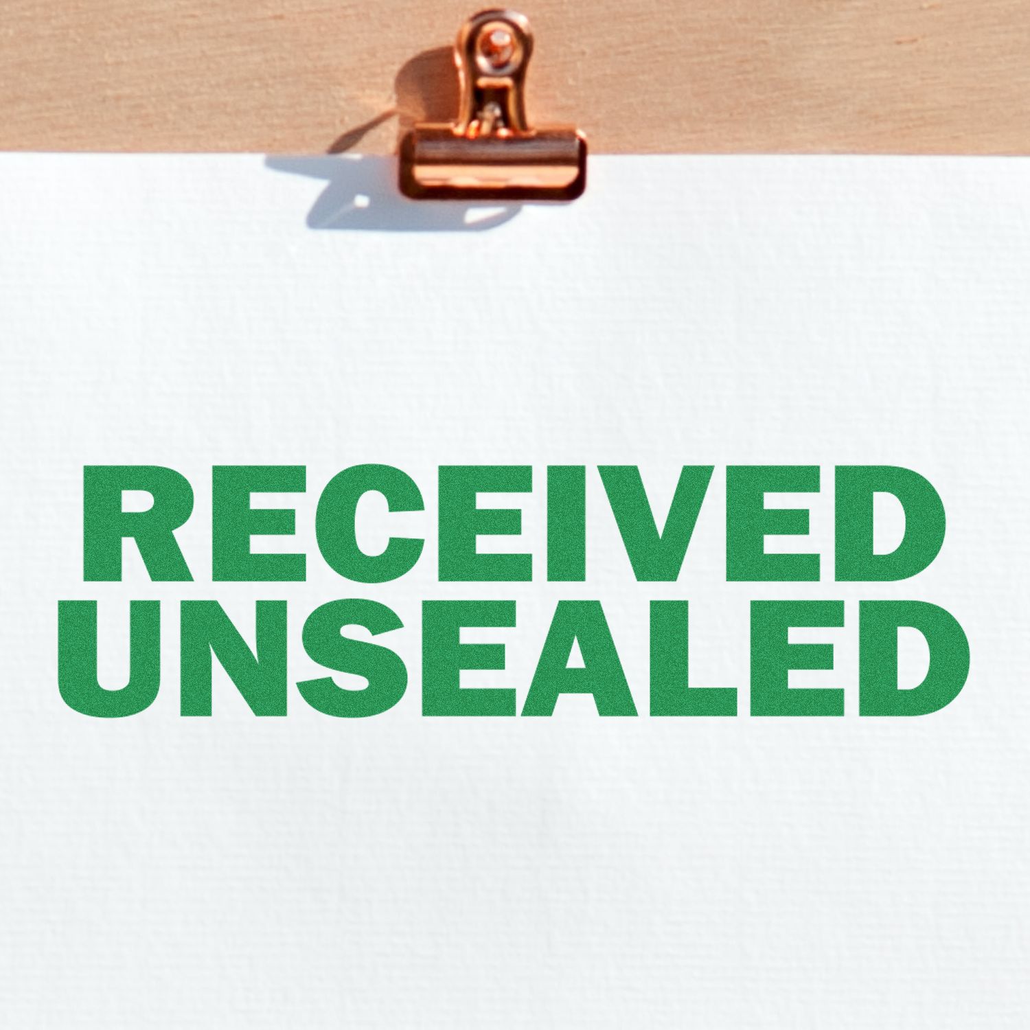 Clipboard with paper stamped RECEIVED UNSEALED in green text