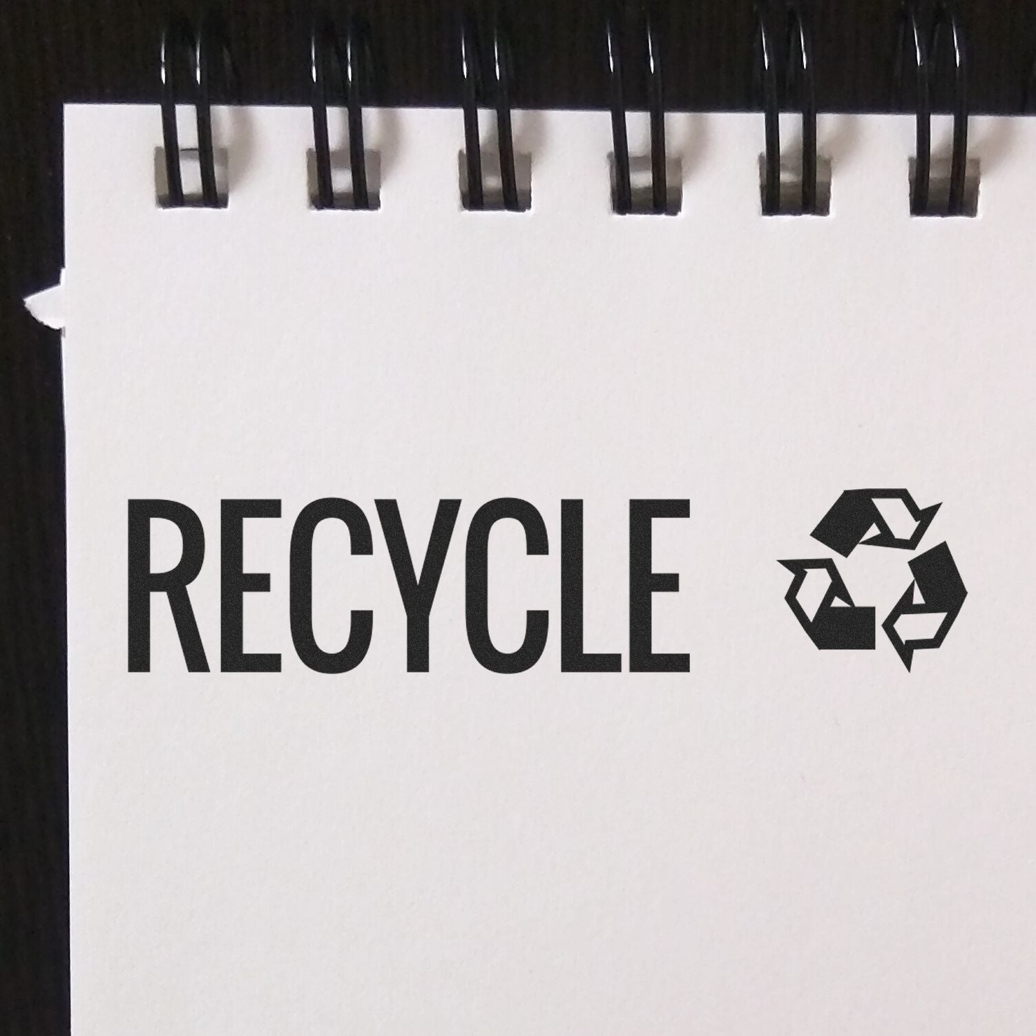 Recycling promotional bag or packaging showing RECYCLE text with recycling symbol for waste sorting awareness