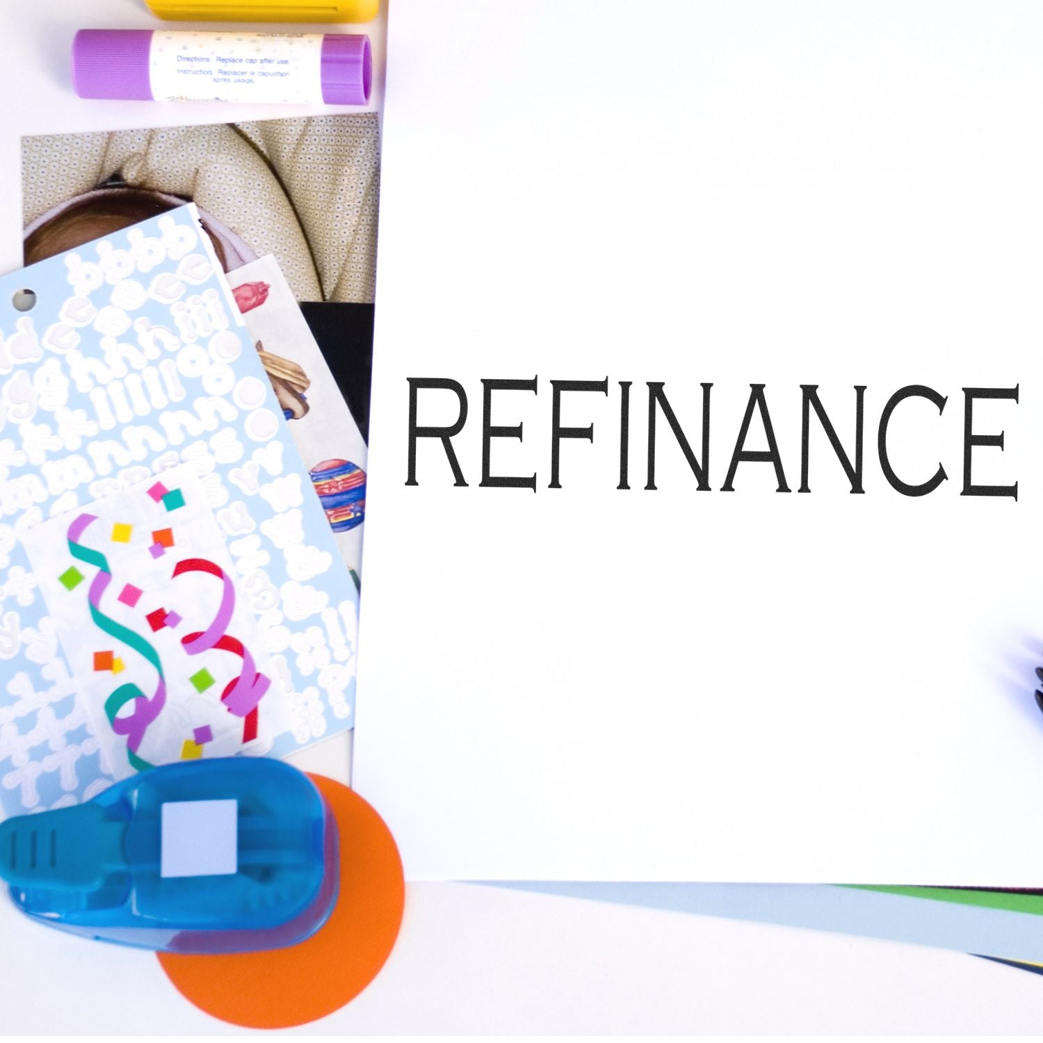 Refinance concept with office supplies, papers and glue on white background, suggesting document review and financial paperwork.