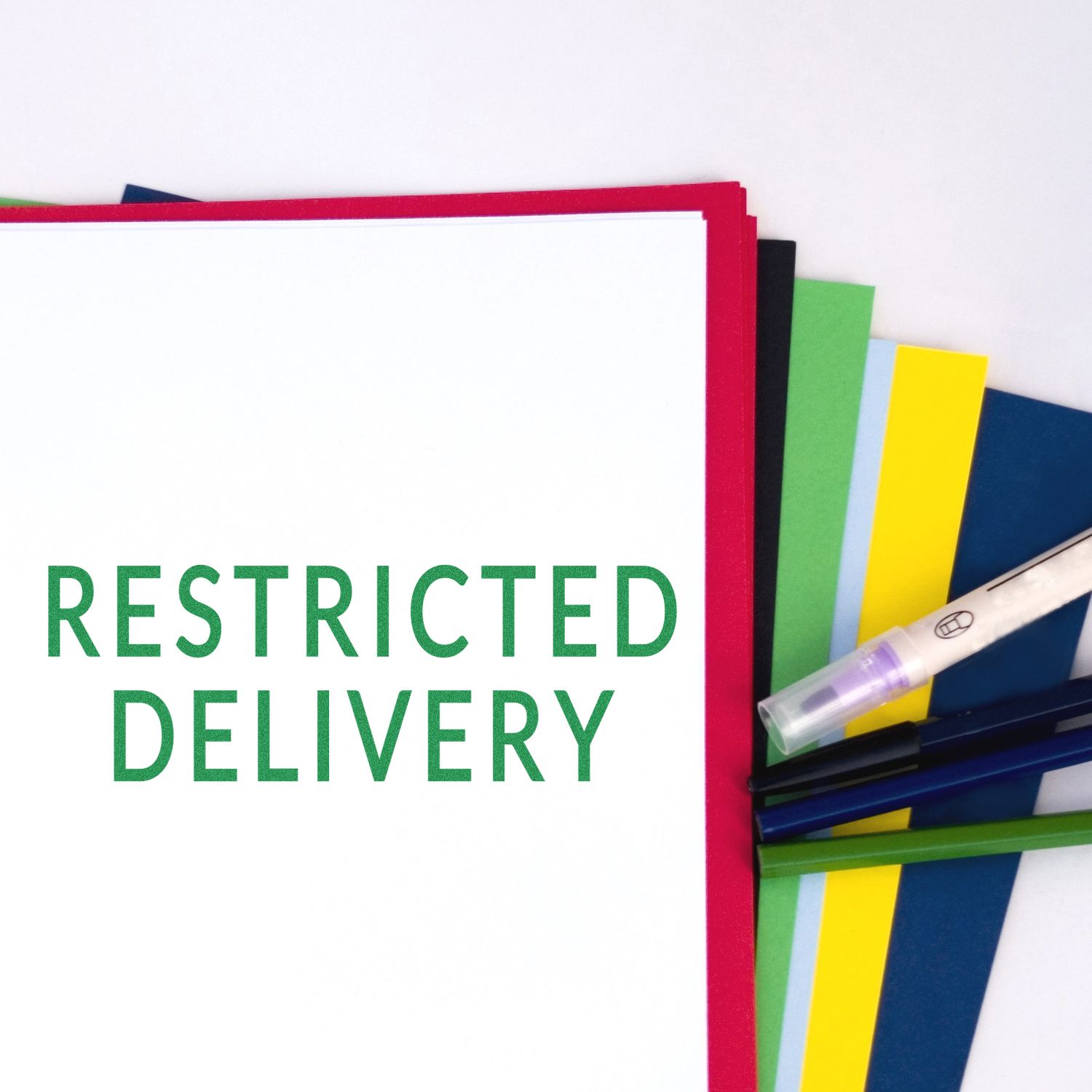 Restricted delivery document folder with colorful office files and pens on a white background.