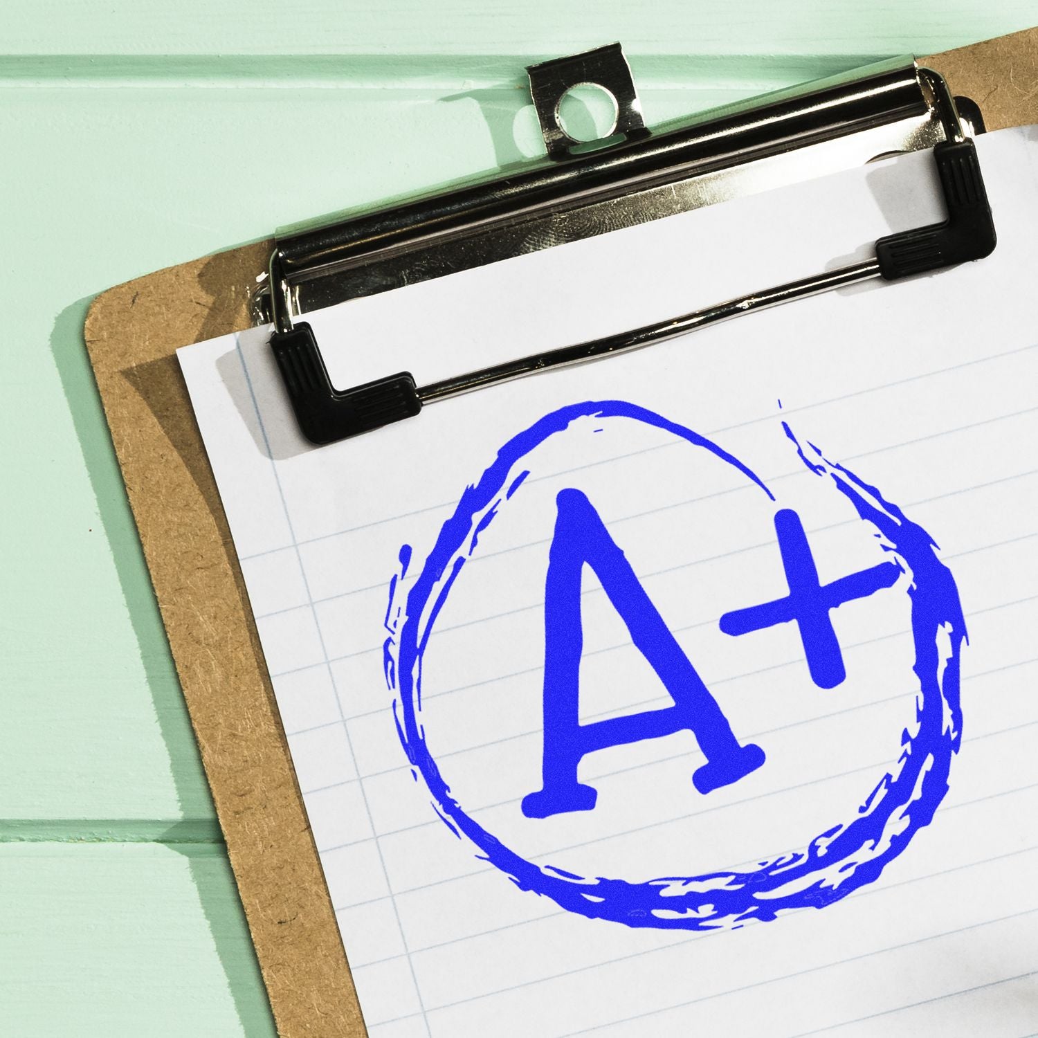 Clipboard with paper showing A+ grade symbol on a clipboard, business success and academic excellence concept.