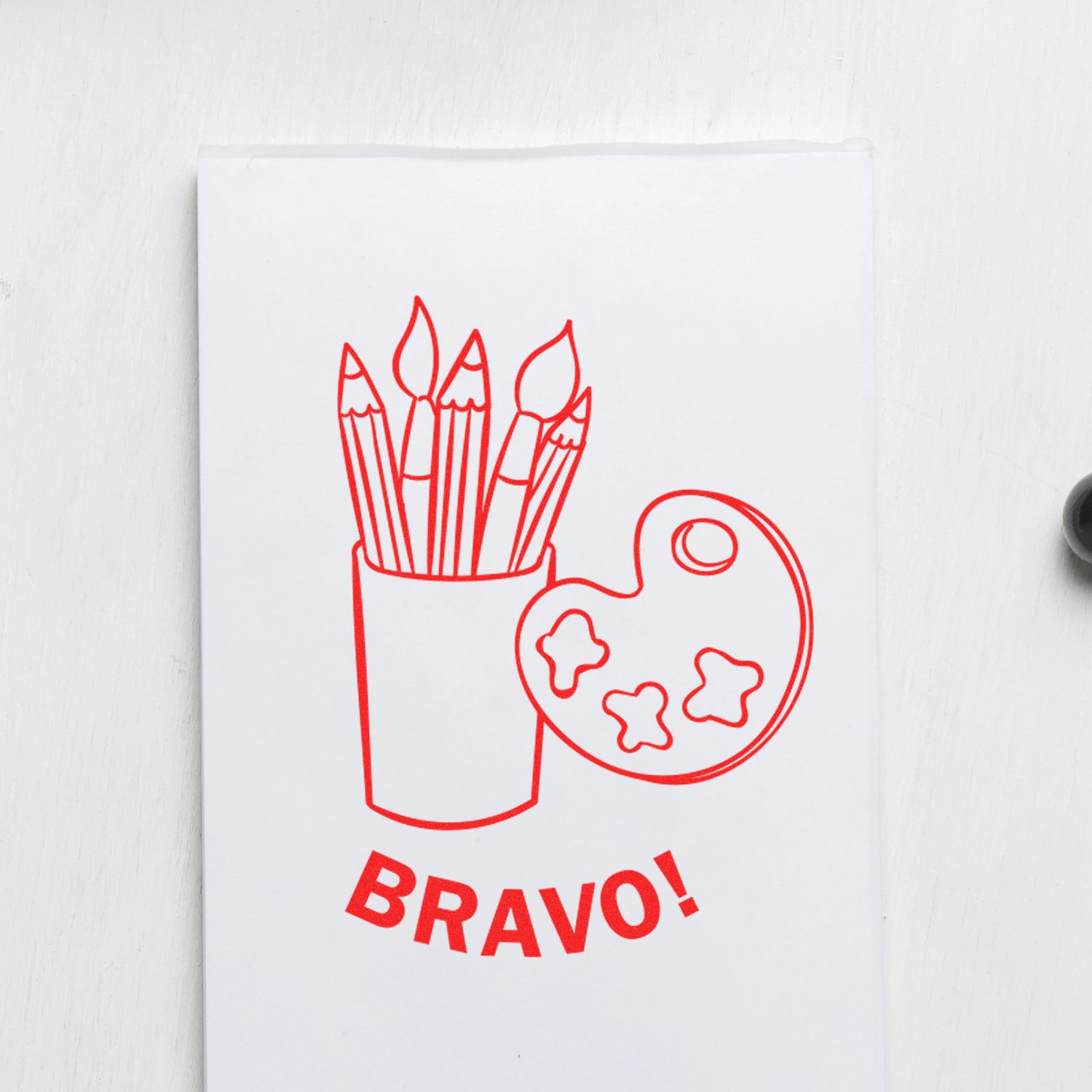 Red Bravo art print with paintbrushes in a cup and artist palette on a white background