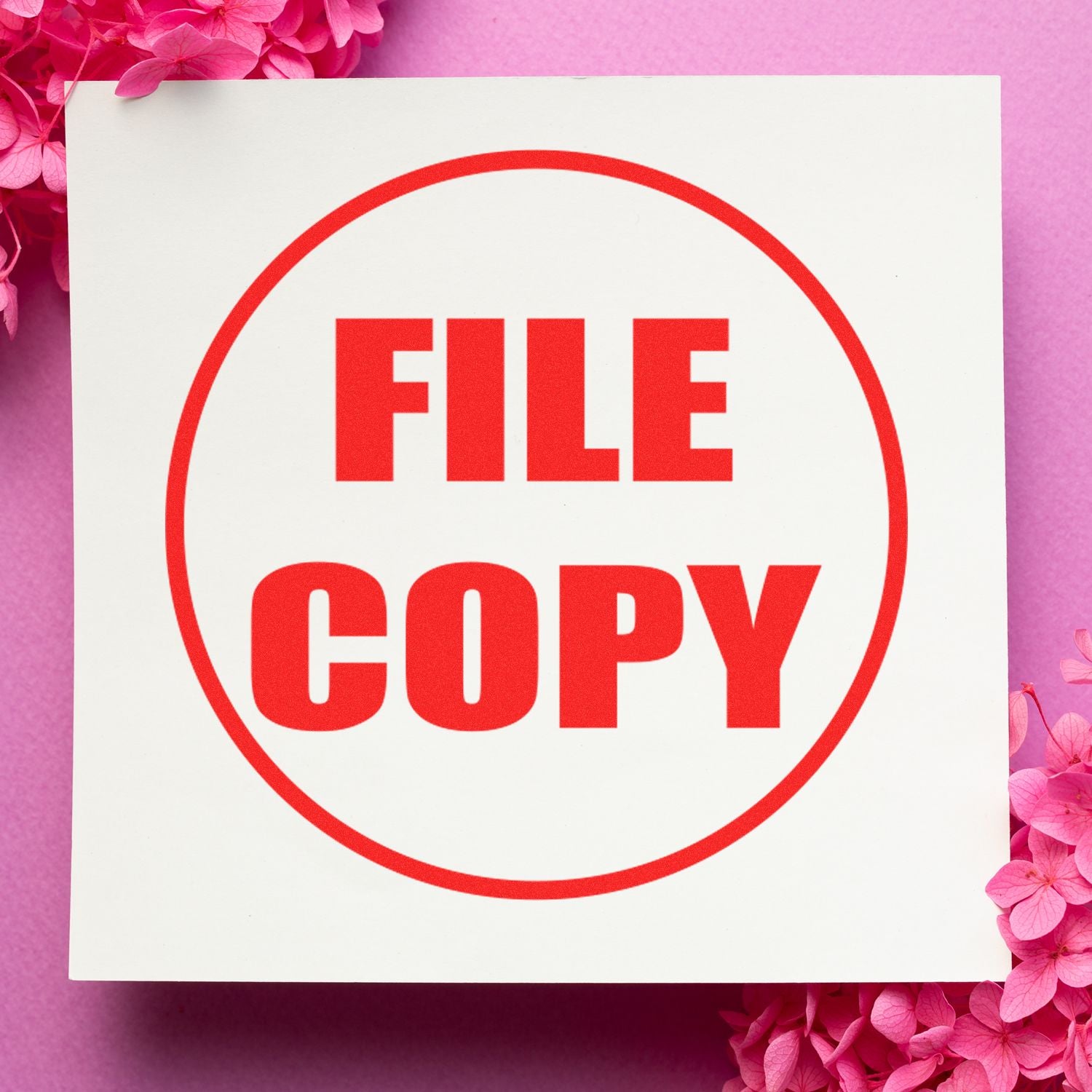 Red FILE COPY stamp on white paper with pink floral background