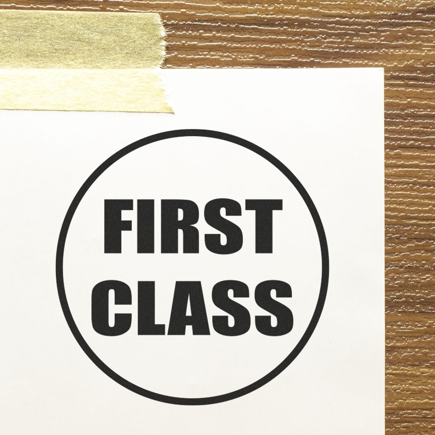 First class bold typography sign on white paper taped to a wooden background.