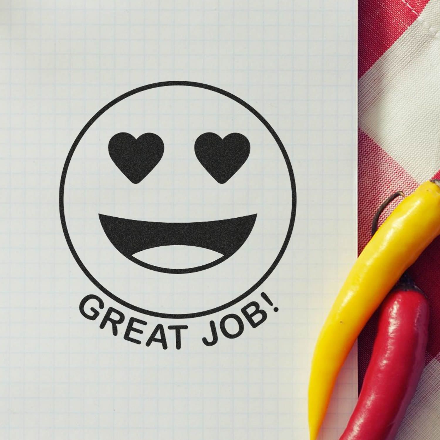 Heart eyes smiley with Great Job! text on graph paper, celebrating success and positive motivation.