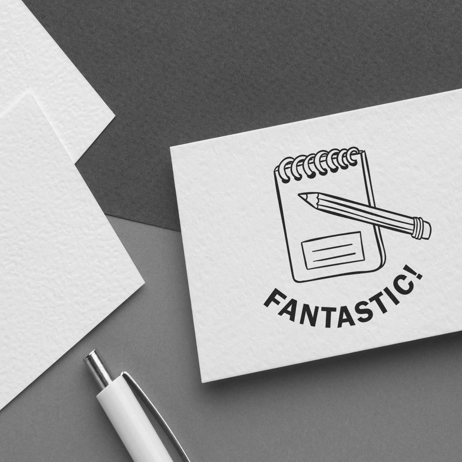 Black and white flat lay of a notebook with pencil and the word FANTASTIC! for a creative writing or education concept.