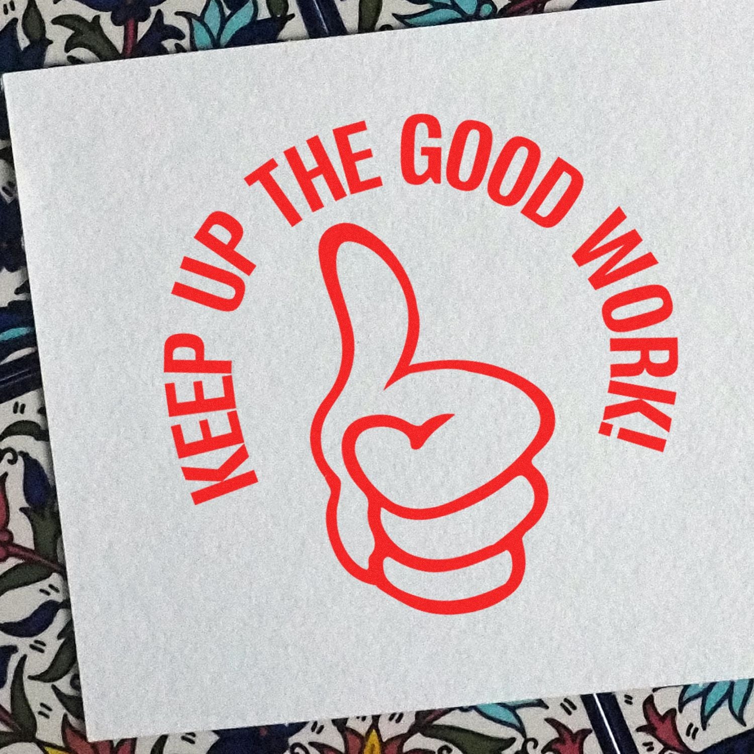 Red Keep Up the Good Work! motivational thumbs-up graphic on white paper background.