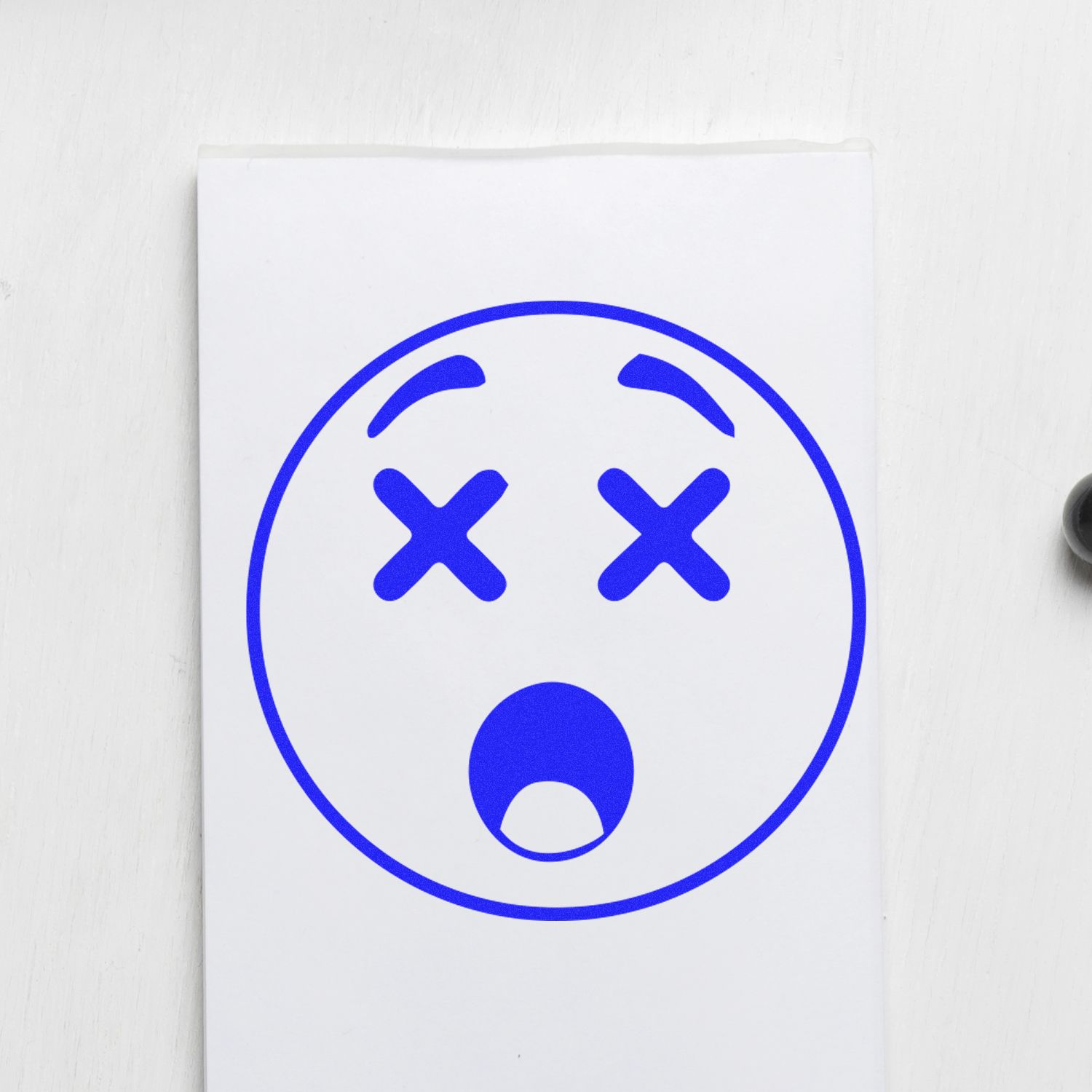 Blue dead face emoji graphic with X eyes and open mouth on a white background.