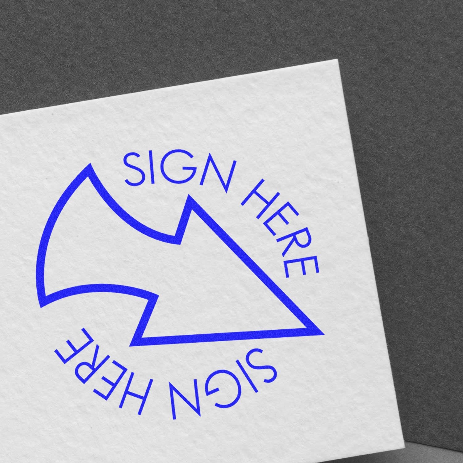 Blue Sign Here arrow icon on white paper document against a dark gray background.