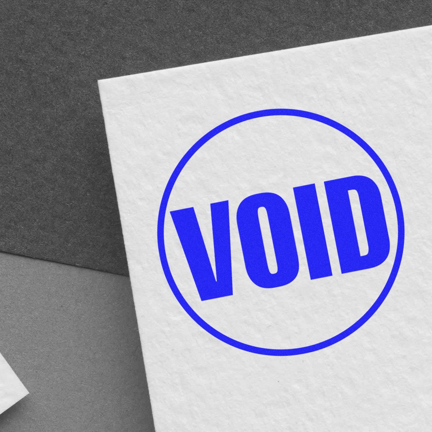 Blue VOID stamp on white paper with circular border, indicating an invalid or canceled document.
