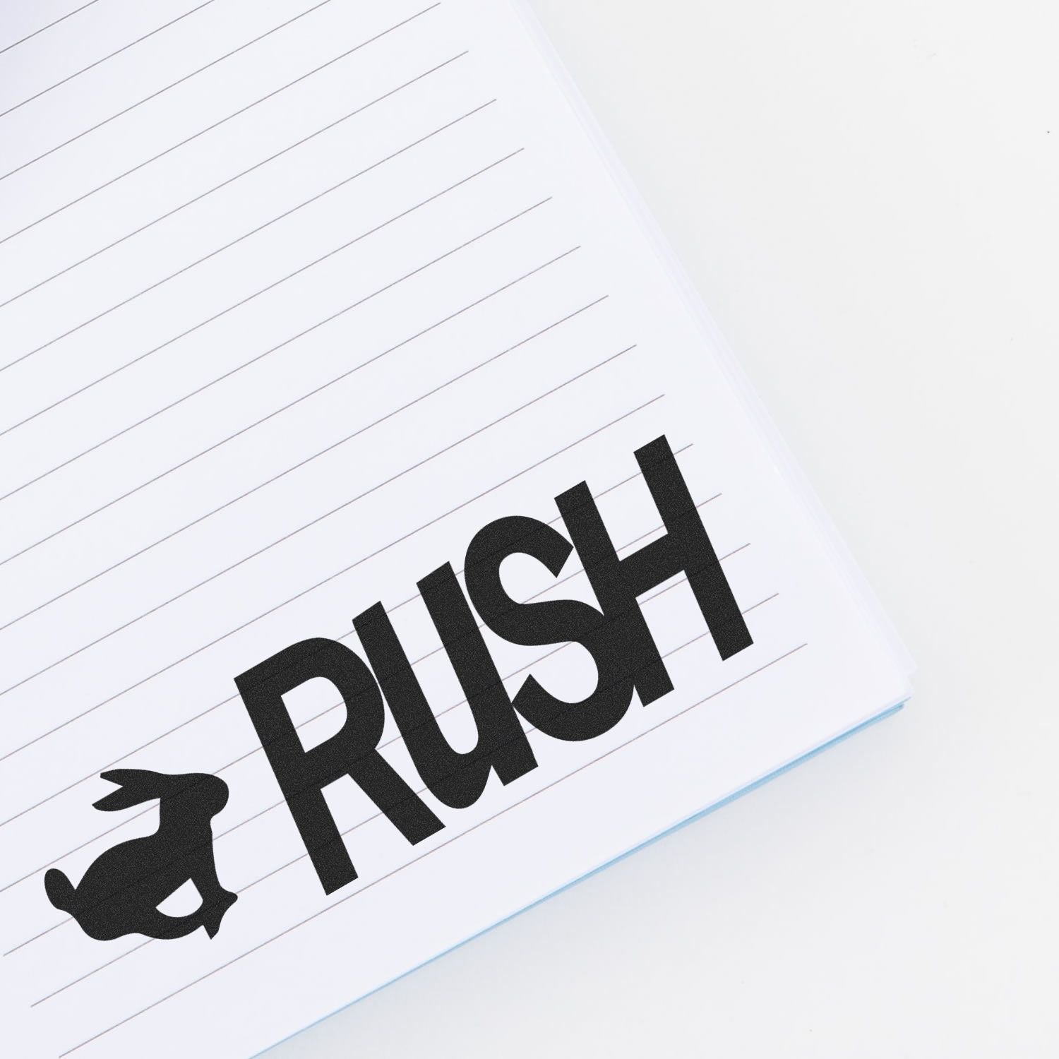 RUSH word on lined notepad, highlighting emergency shipping and expedited service branding