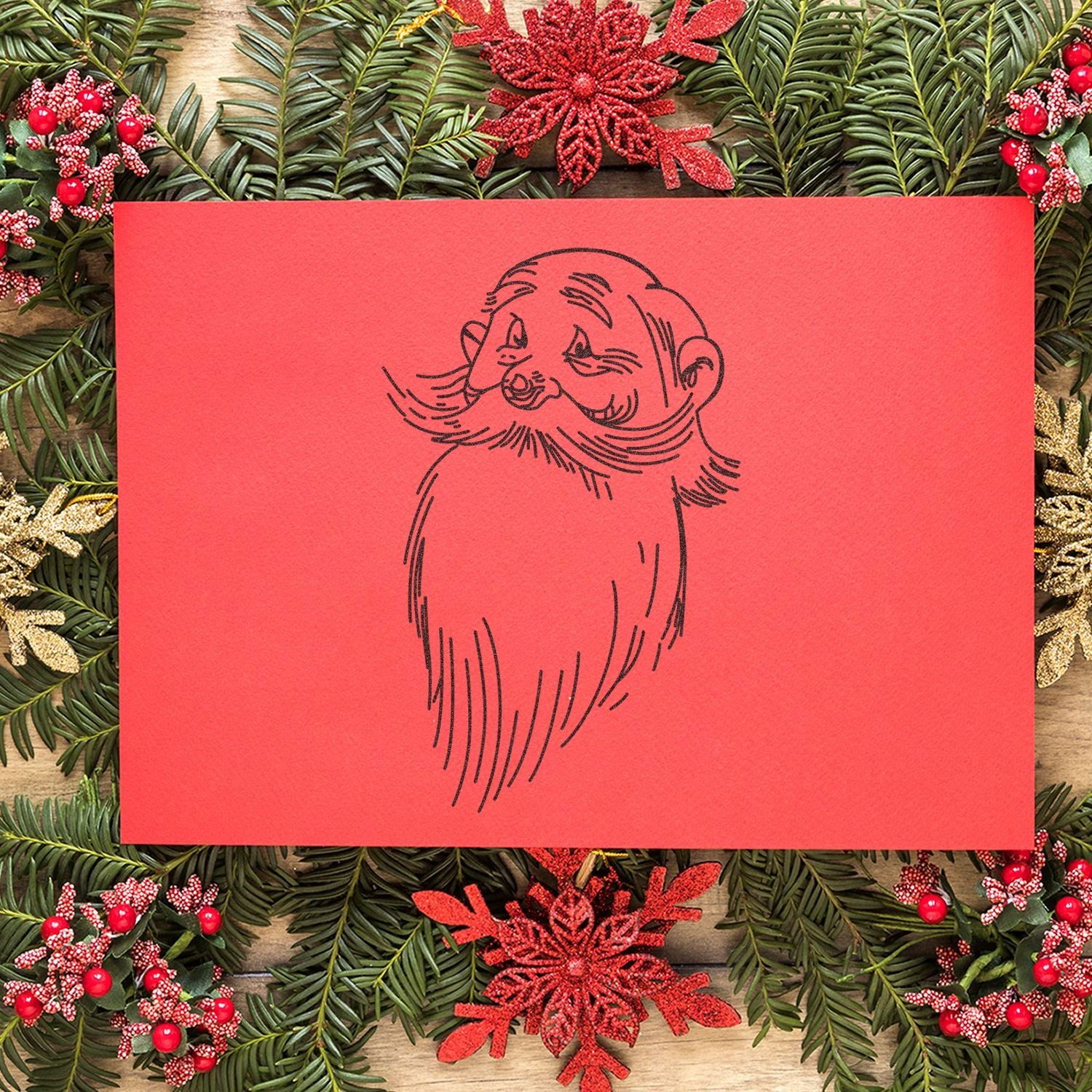 Red Christmas card with Santa illustration surrounded by festive evergreen wreath and red holiday decorations.