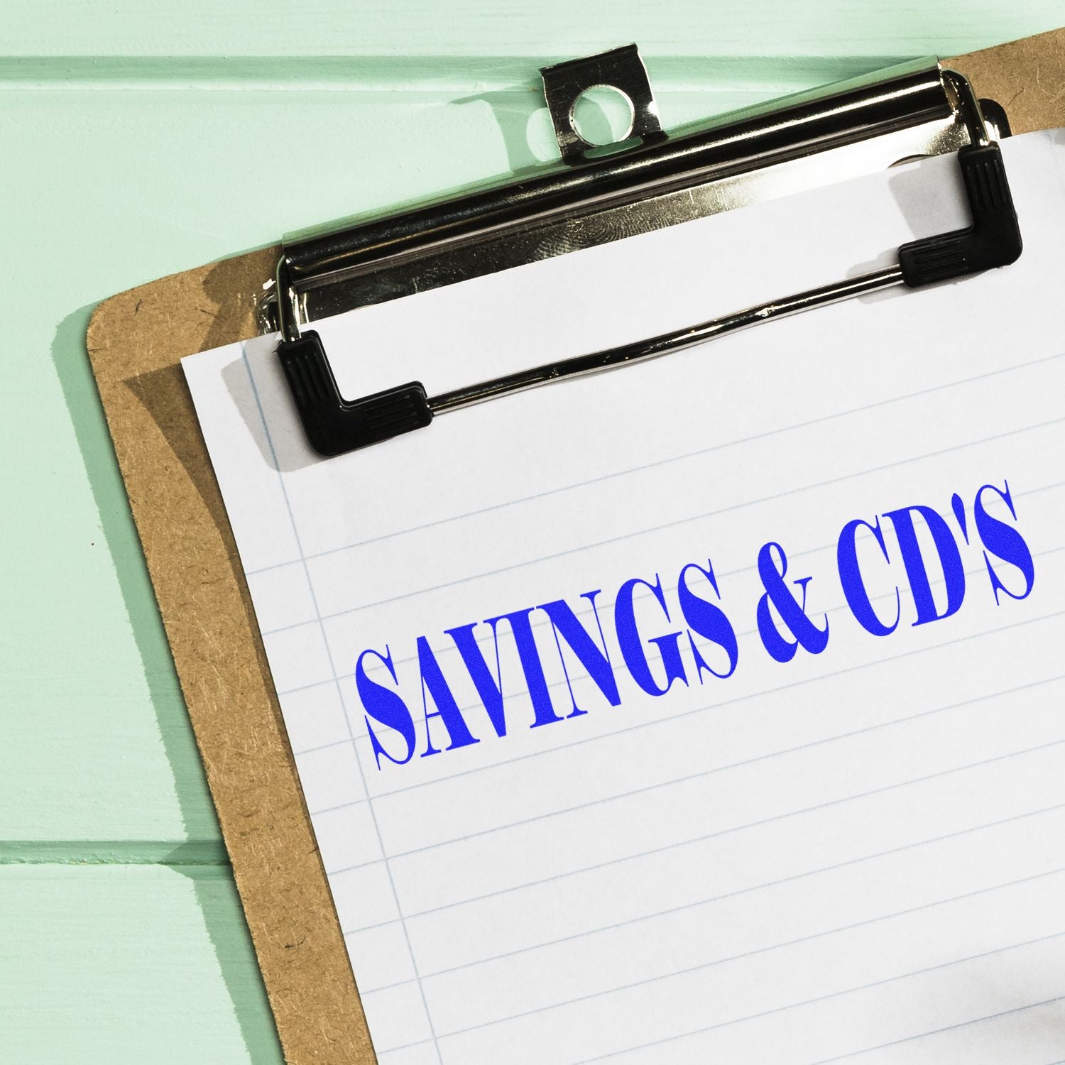 Clipboard with notepad showing Savings & CDs, highlighting personal finance savings and certificates of deposit planning.