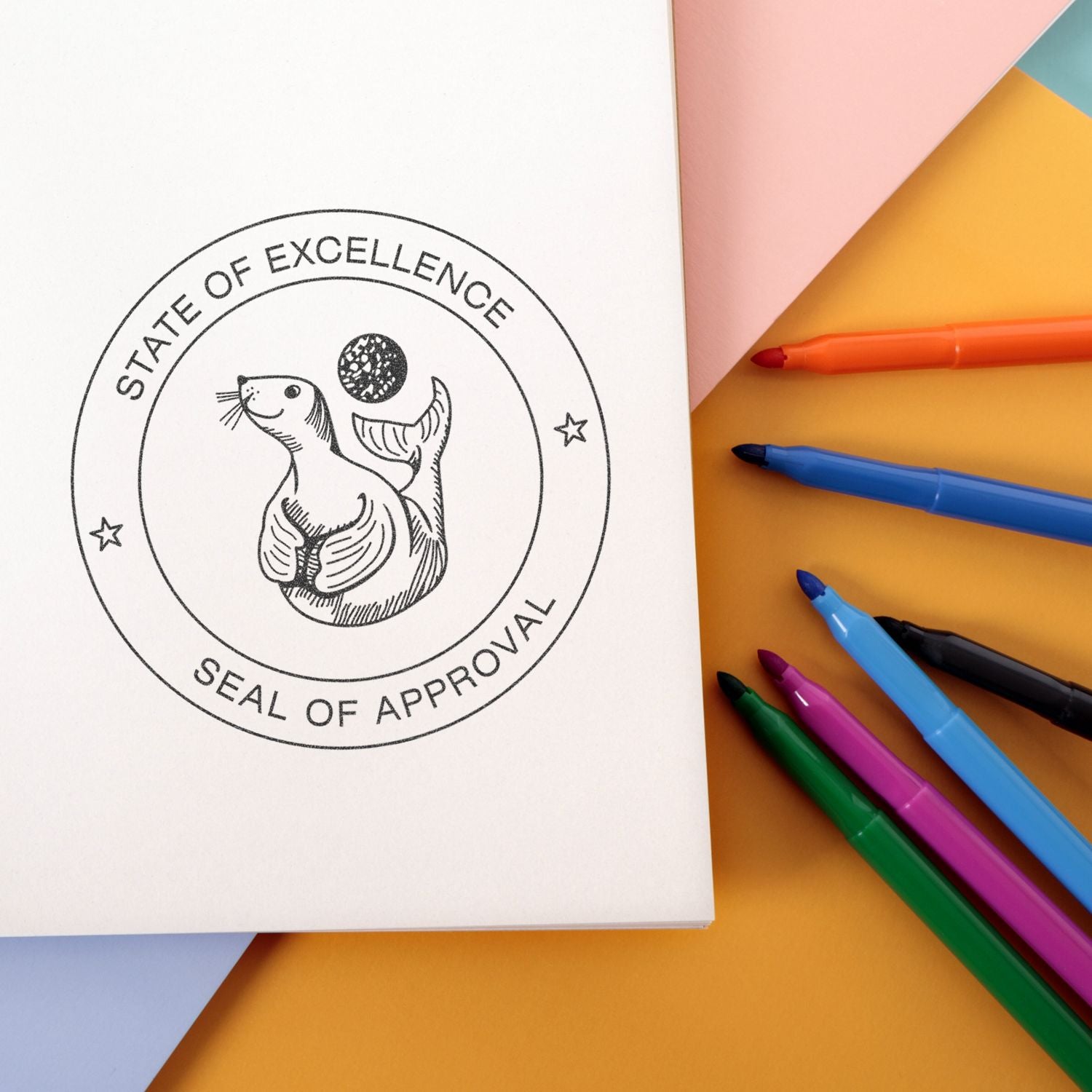 Notebook mockup with sea lion seal of approval stamp and colorful markers on pastel background