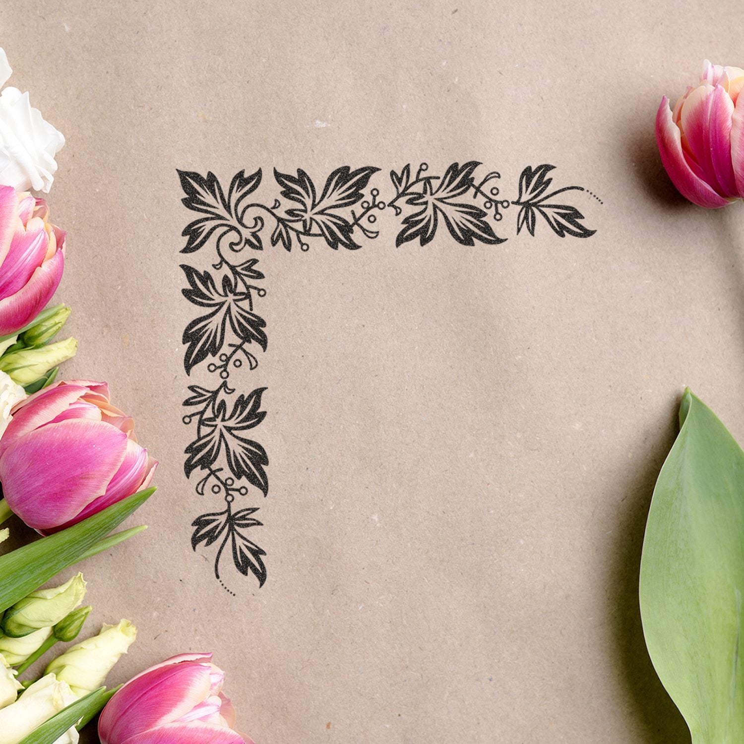 Elegant floral corner border on kraft paper with pink tulips and green leaves, botanical frame background design