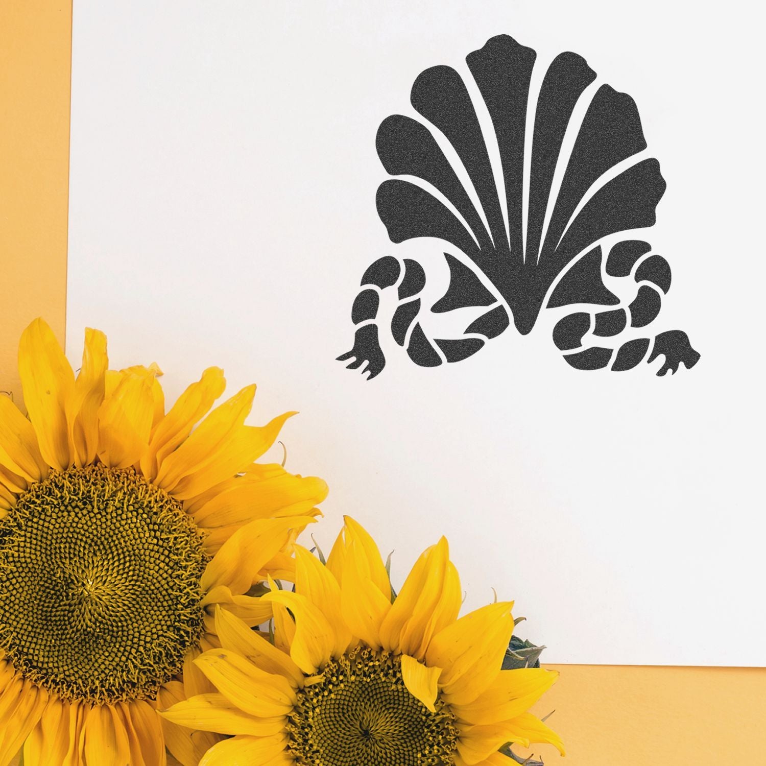 Bright yellow sunflowers with a black floral wall stencil on a white background, creating a modern sunflower decor design.