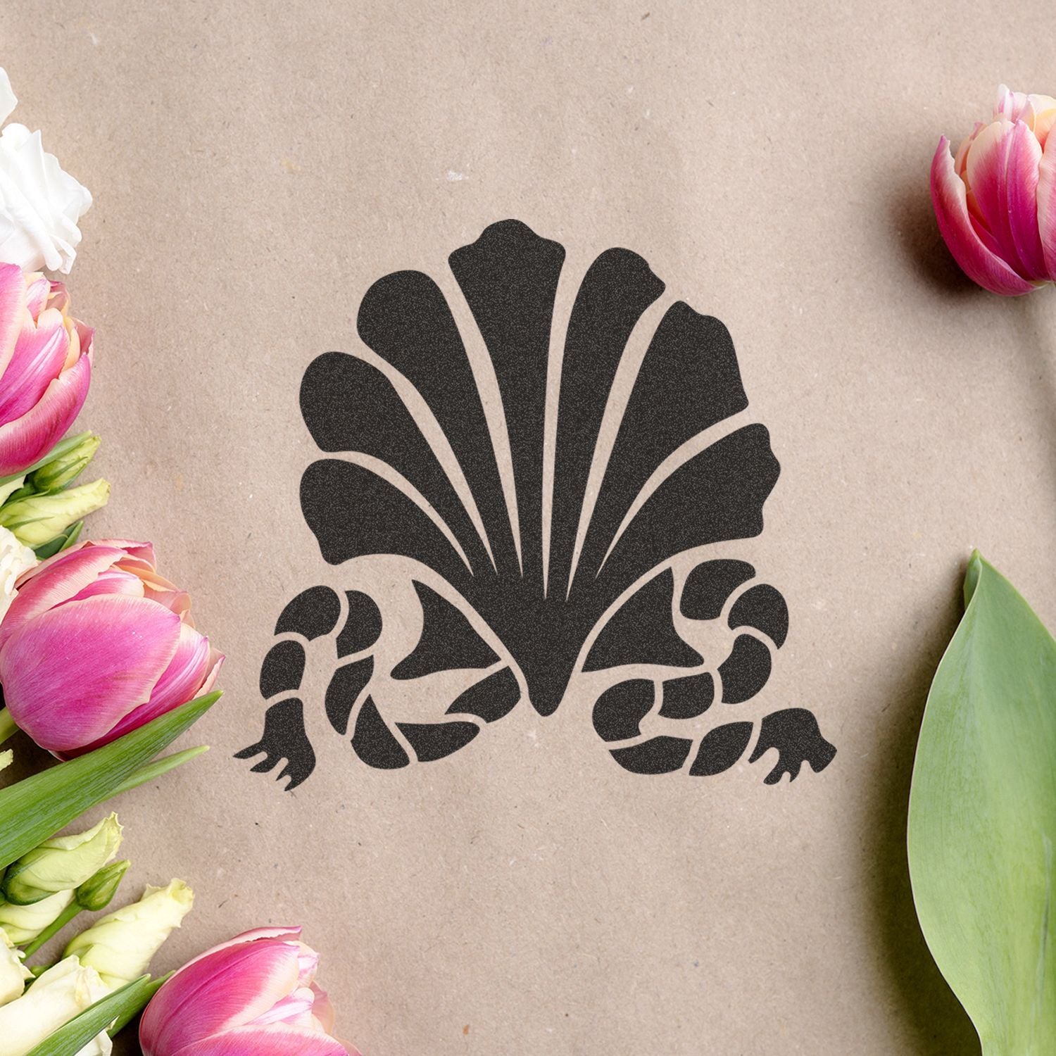 Stylized black shell logo on kraft paper with pink tulips and green leaves around the edges.