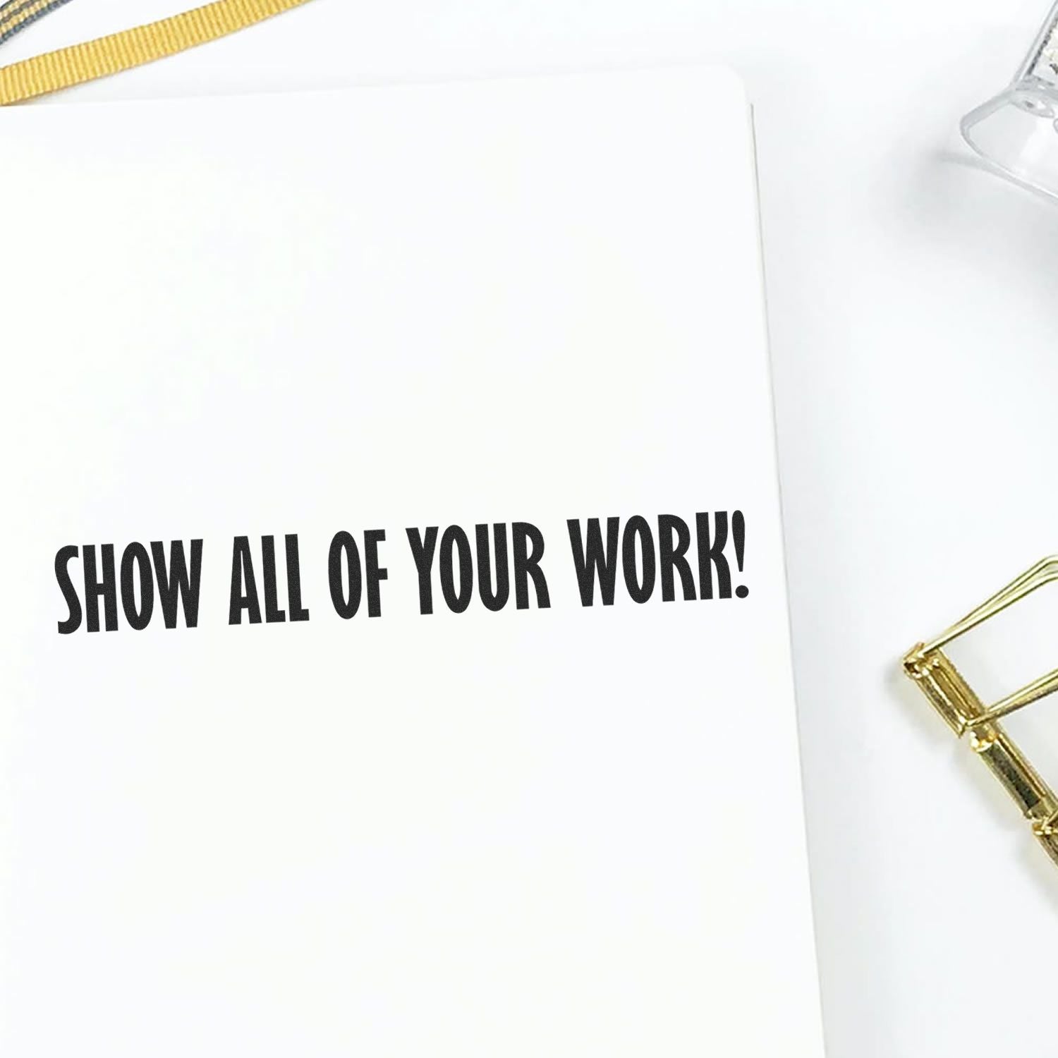 Minimal white notebook with Show All of Your Work! quote, gold paperclip, and clean desk flat lay design.