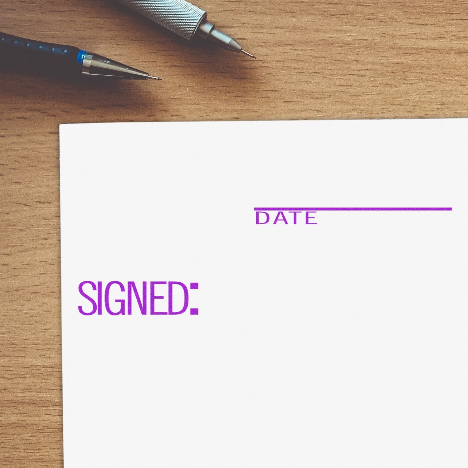 Signed document template with date field on wooden desk with pens, symbolizing contract approval and verification.