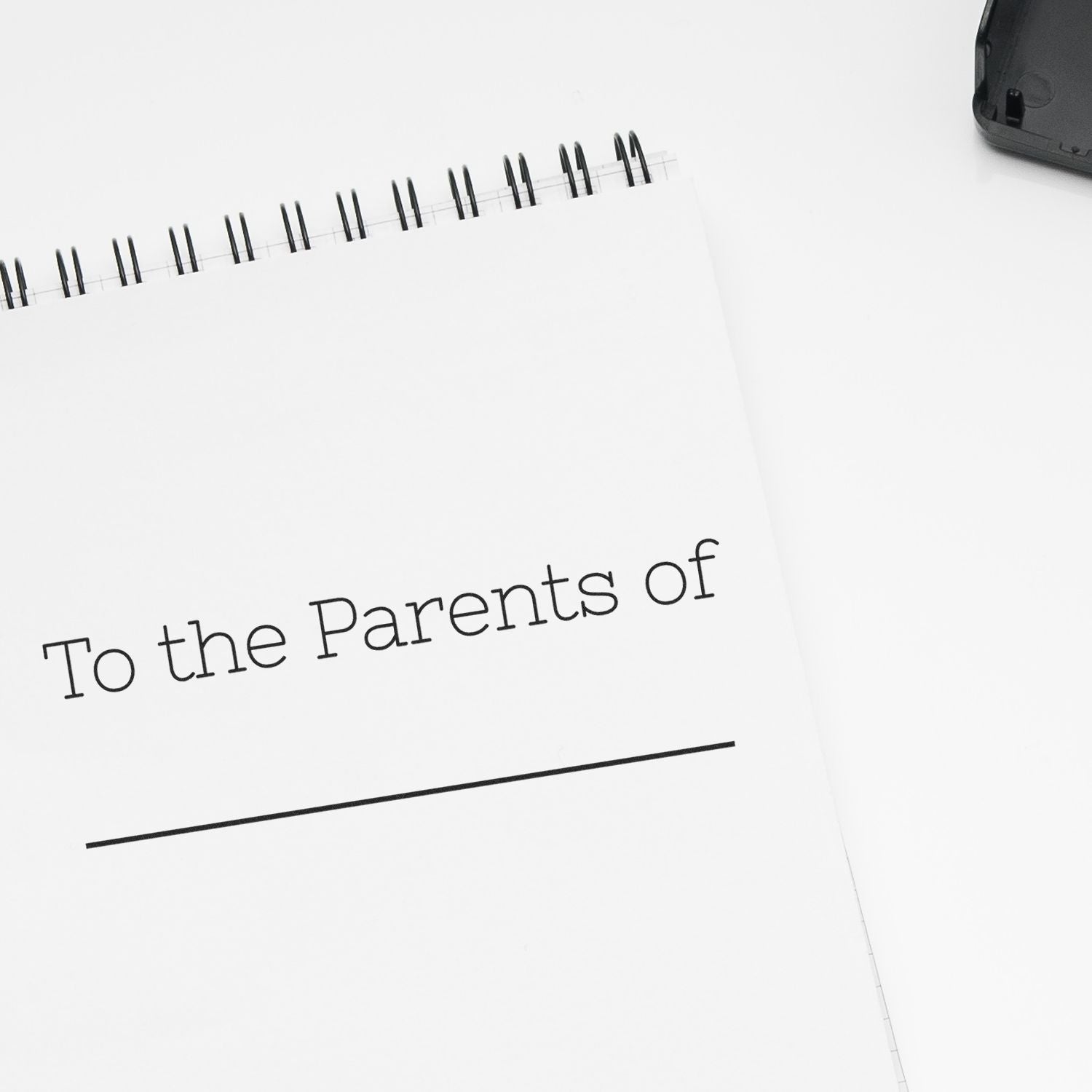 Parenting guide notebook page reading To the Parents of, with binder rings, for school or child support communication