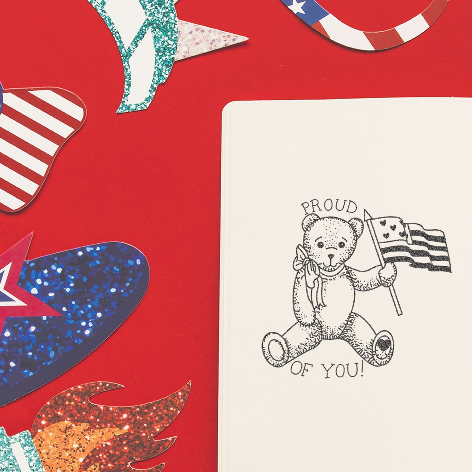 Patriotic notebook with teddy bear holding an American flag on a red background with colorful star decorations