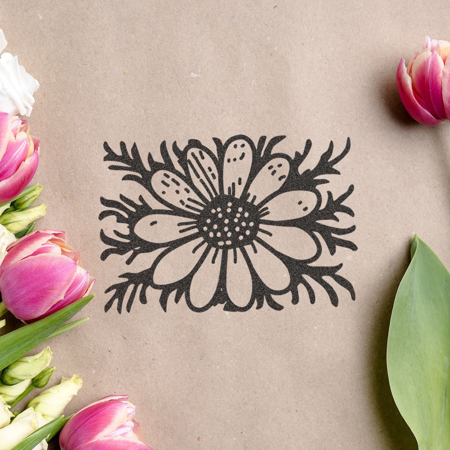 Black floral illustration on kraft paper surrounded by pink tulips and white flowers, featuring a spring gift wrap or greeting card design.