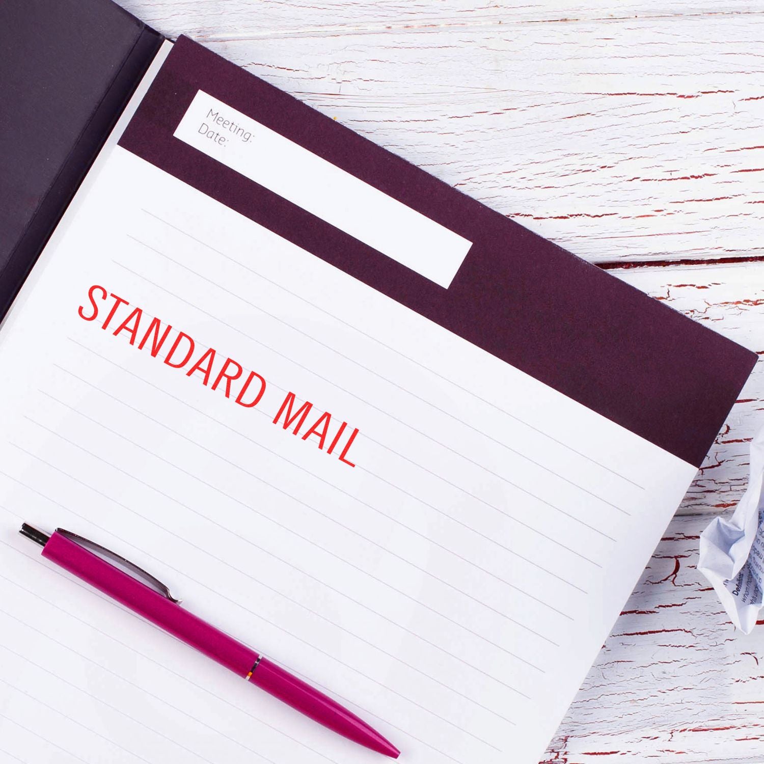 Standard mail folder with pink pen on a white wooden desk, office stationery and mailing concept.