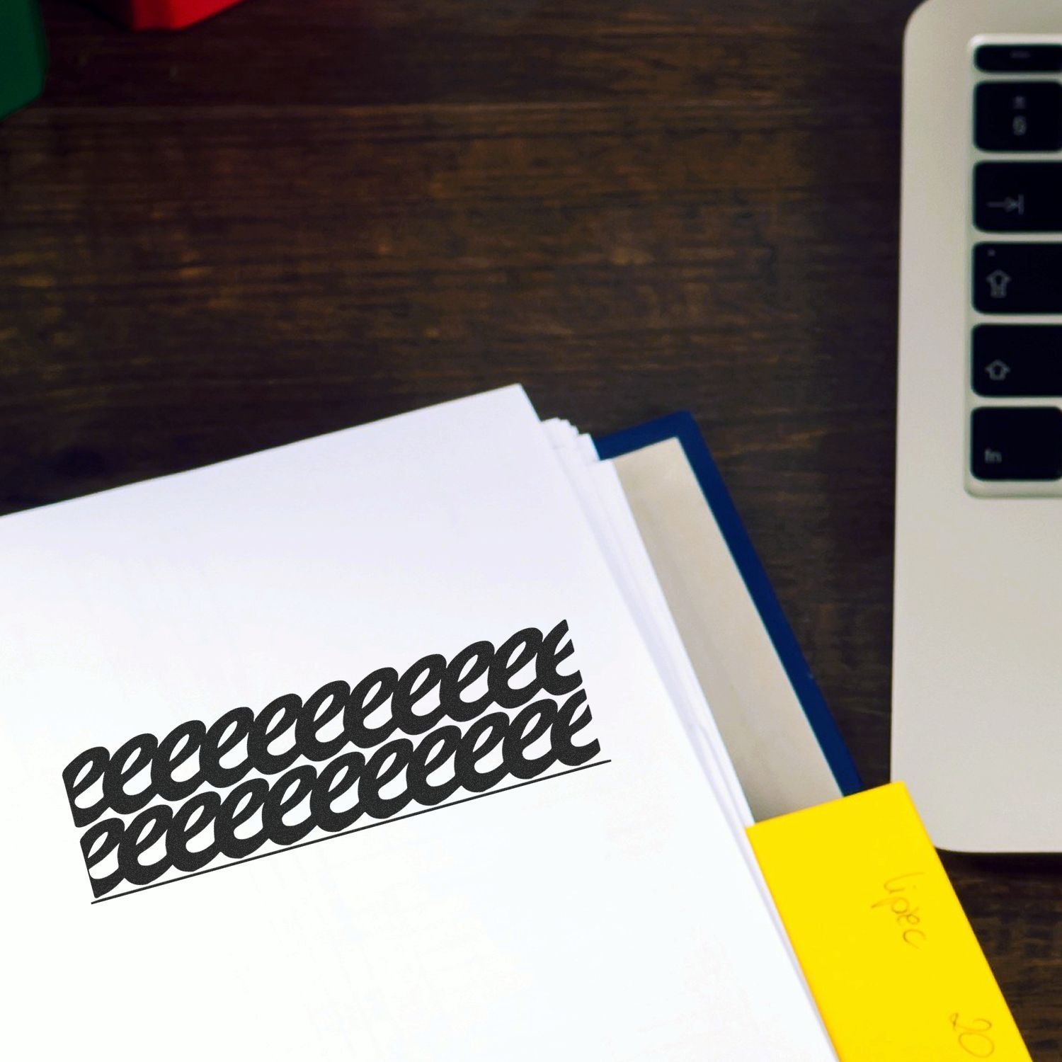Laptop keyboard beside printed documents and sticky notes on a wooden office desk, top view workspace scene.