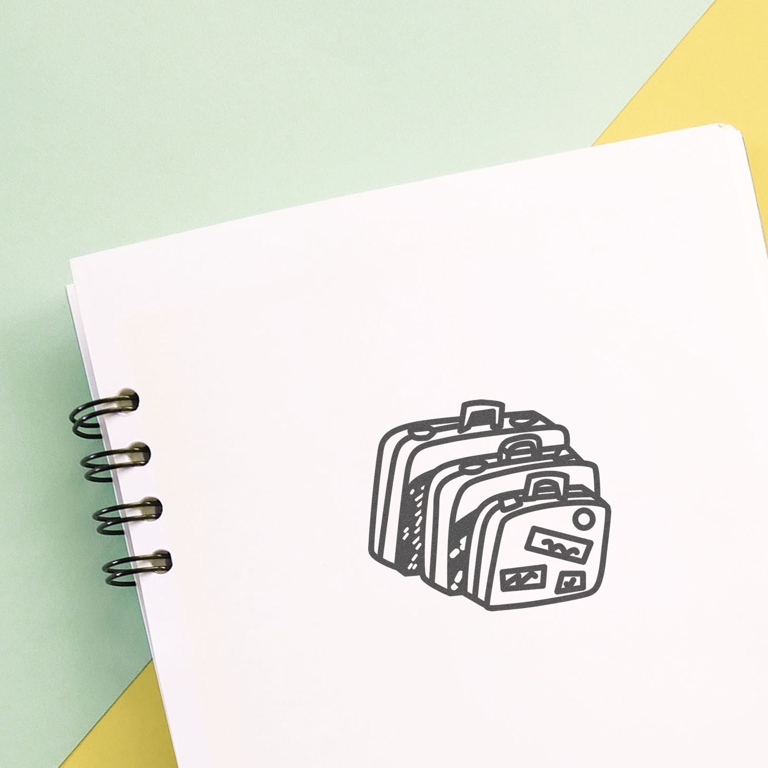 Blank spiral notebook with backpack icon on pastel background, school supplies concept.