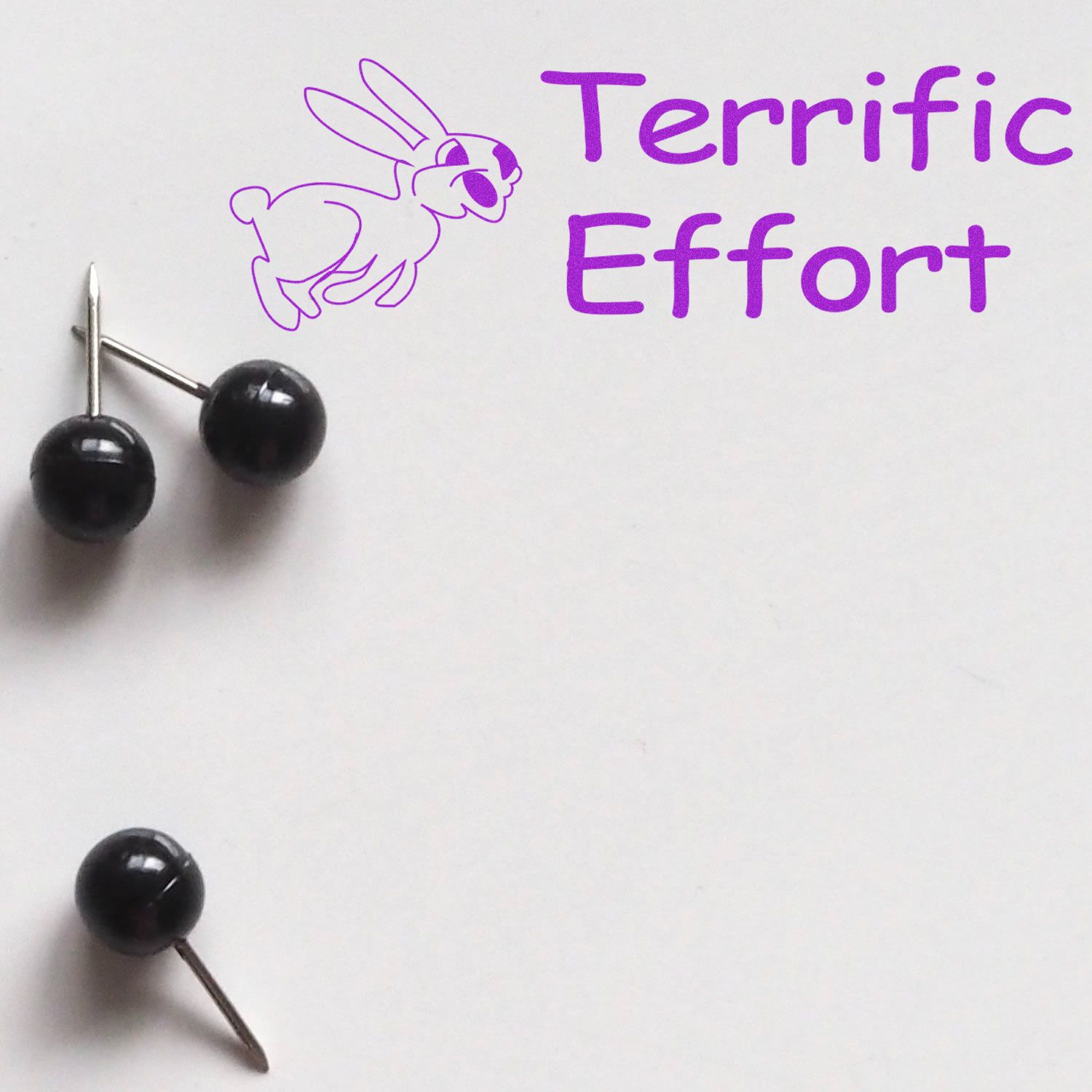 Purple Terrific Effort motivational message with rabbit illustration and push pins on white background.