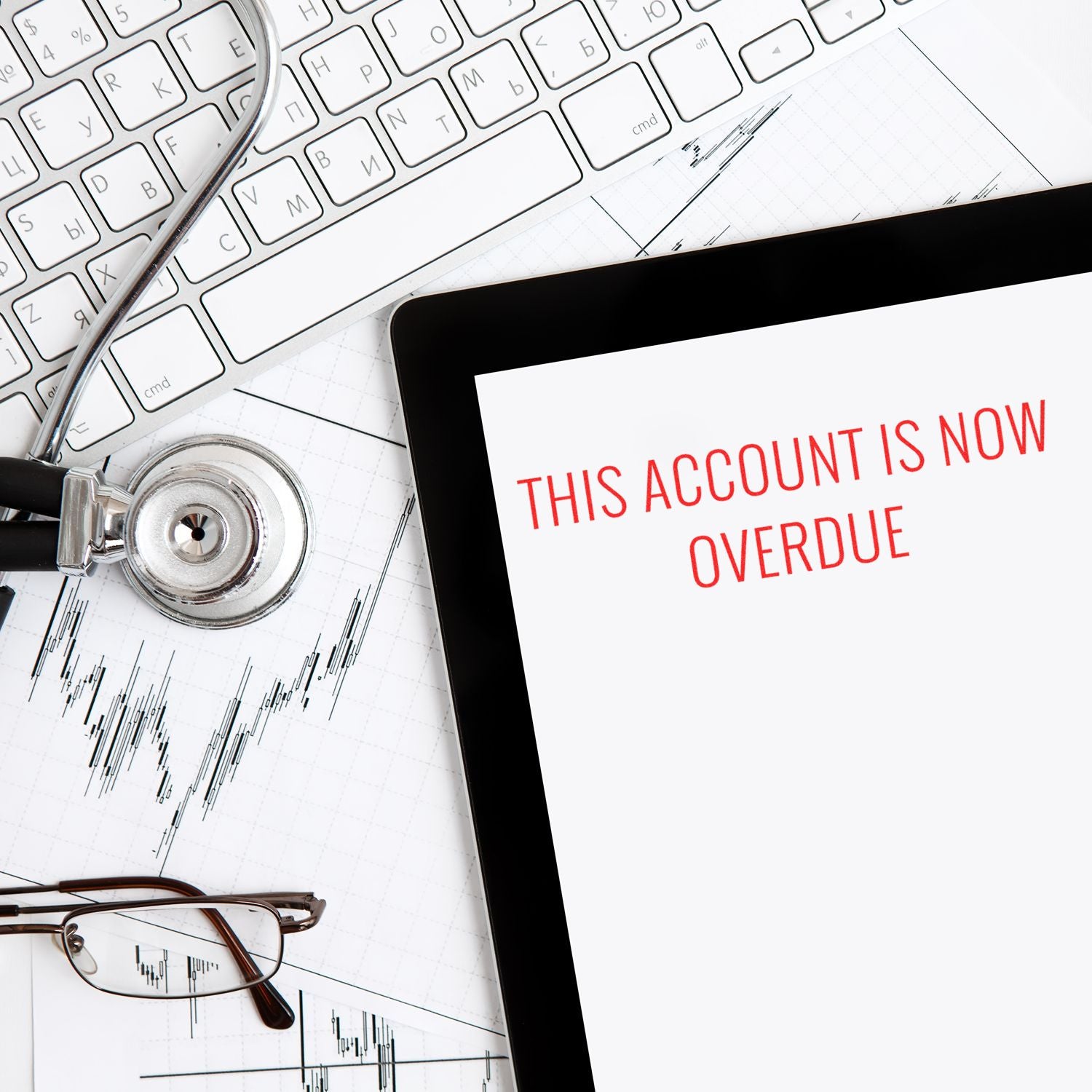 Accounting overdue warning with stethoscope, financial charts, and message This account is now overdue on laptop screen.