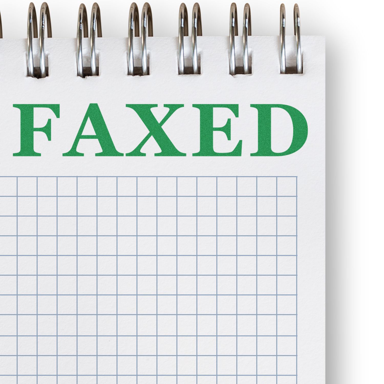 Spiral notebook page with green FAXED text and graph paper grid, representing faxed document status.