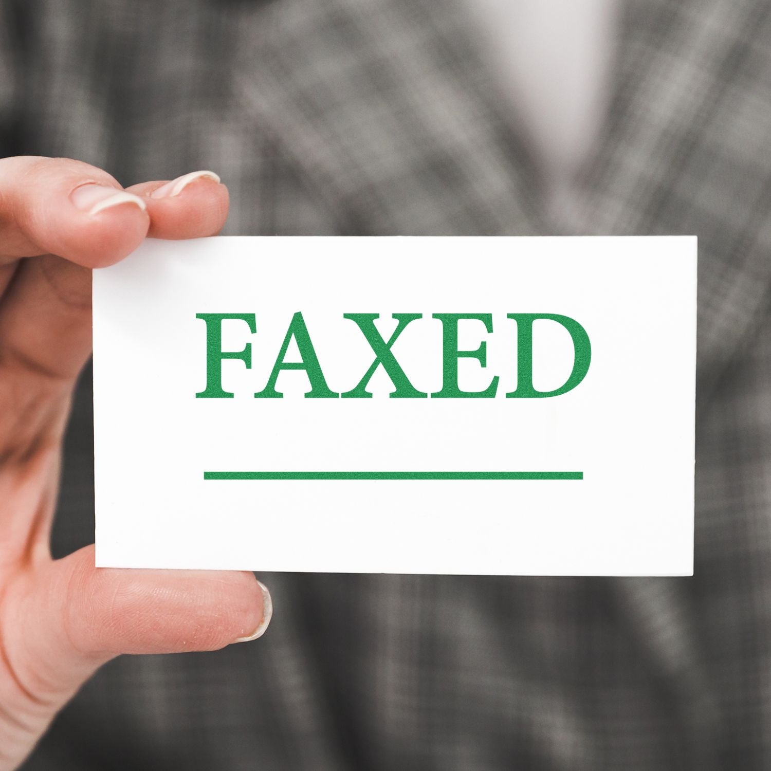 Hand holding card that reads FAXED, symbolizing faxing documents for fast office document workflow.
