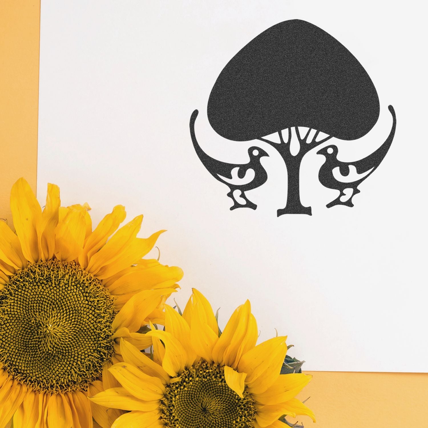 Black tree and birds wall art with bright yellow sunflowers on a white background, modern botanical decor design.