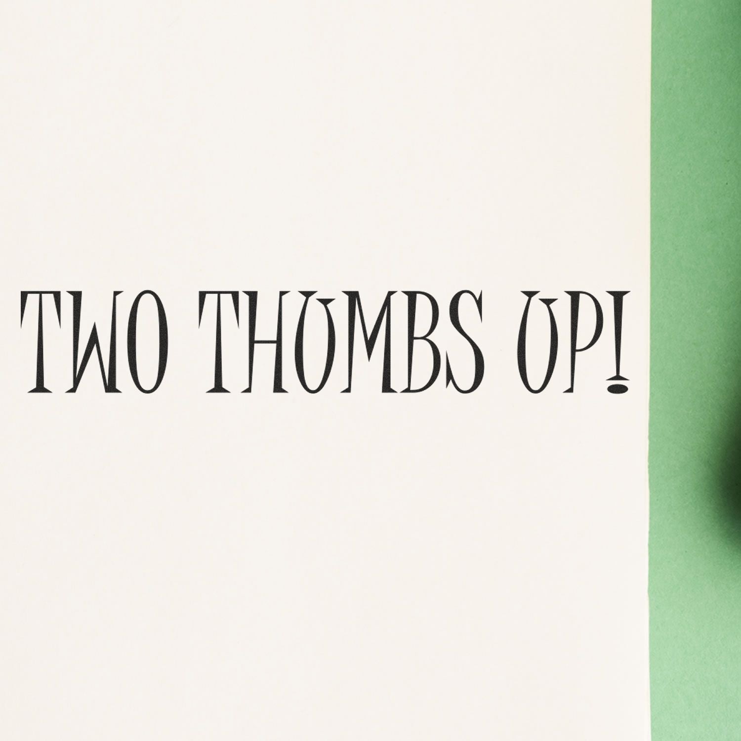 Stylized black text reading Two Thombs Up! on a white background with a green edge.
