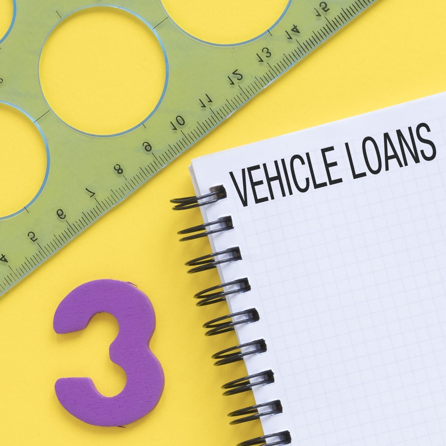Vehicle loan planning with measuring tape, question mark concept, and notebook titled VEHICLE LOANS