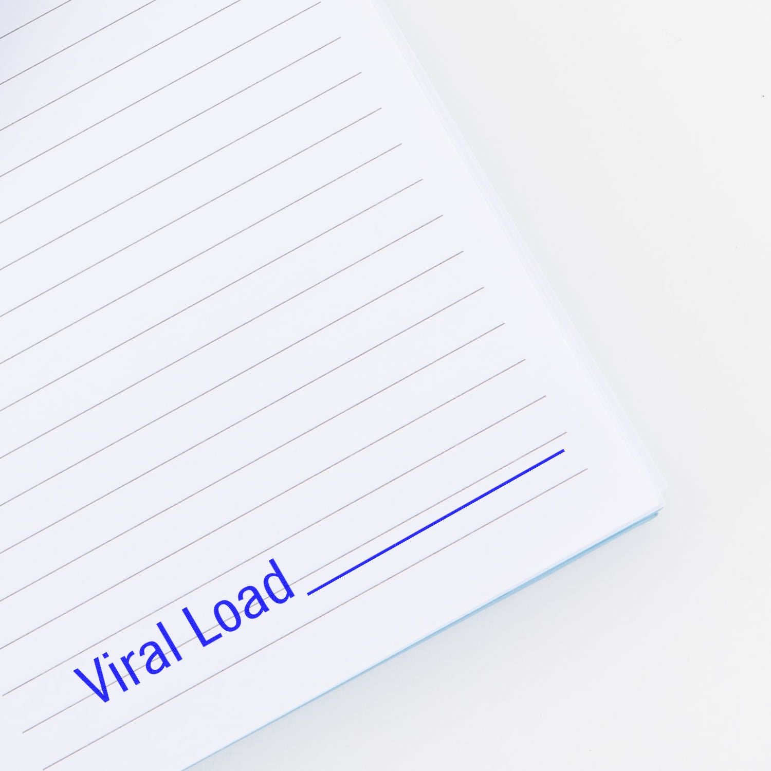 Close-up of a lined notebook page labeled Viral Load in blue text on a white background.