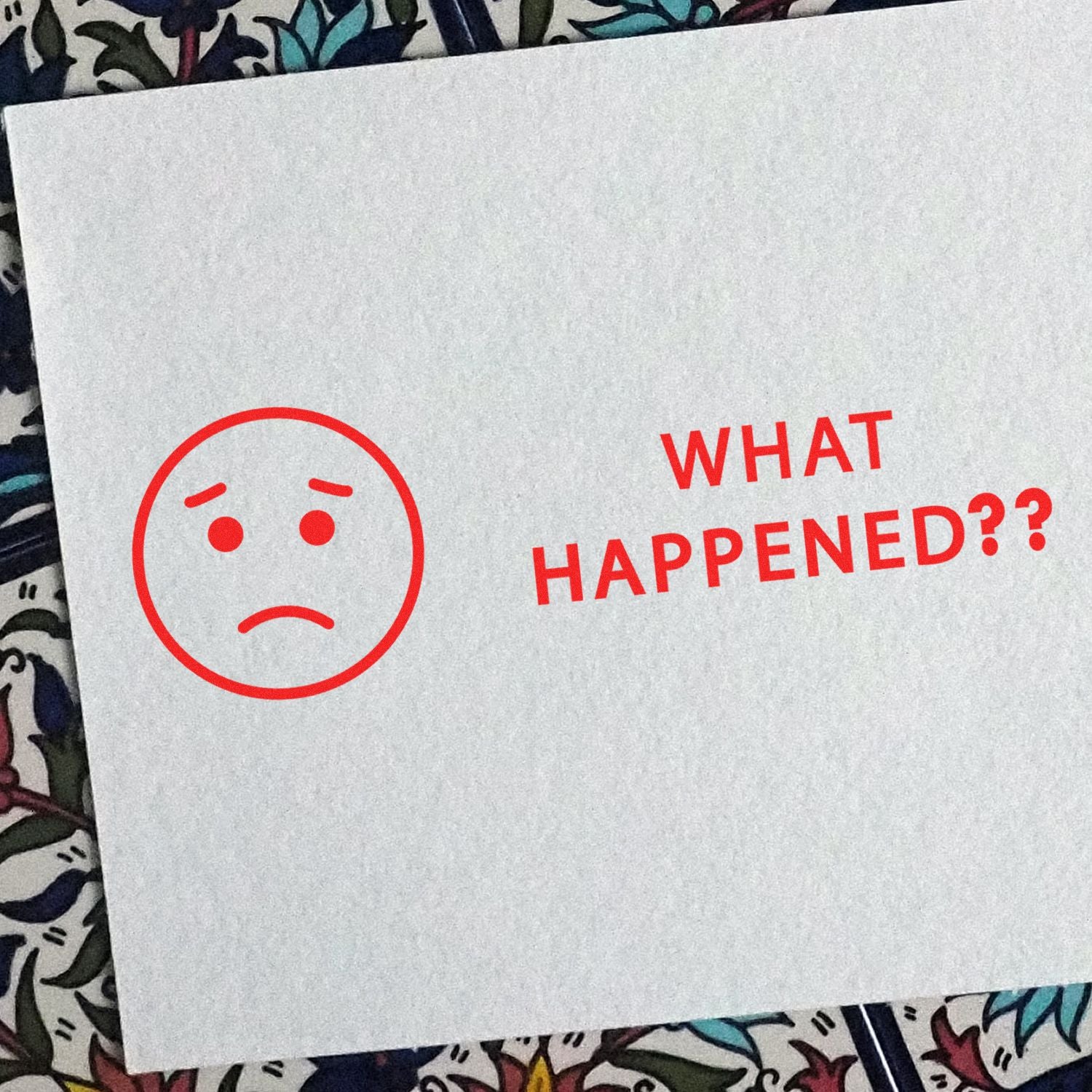 What happened?? sad face emoticon on a white card, conveying confusion and disappointment.